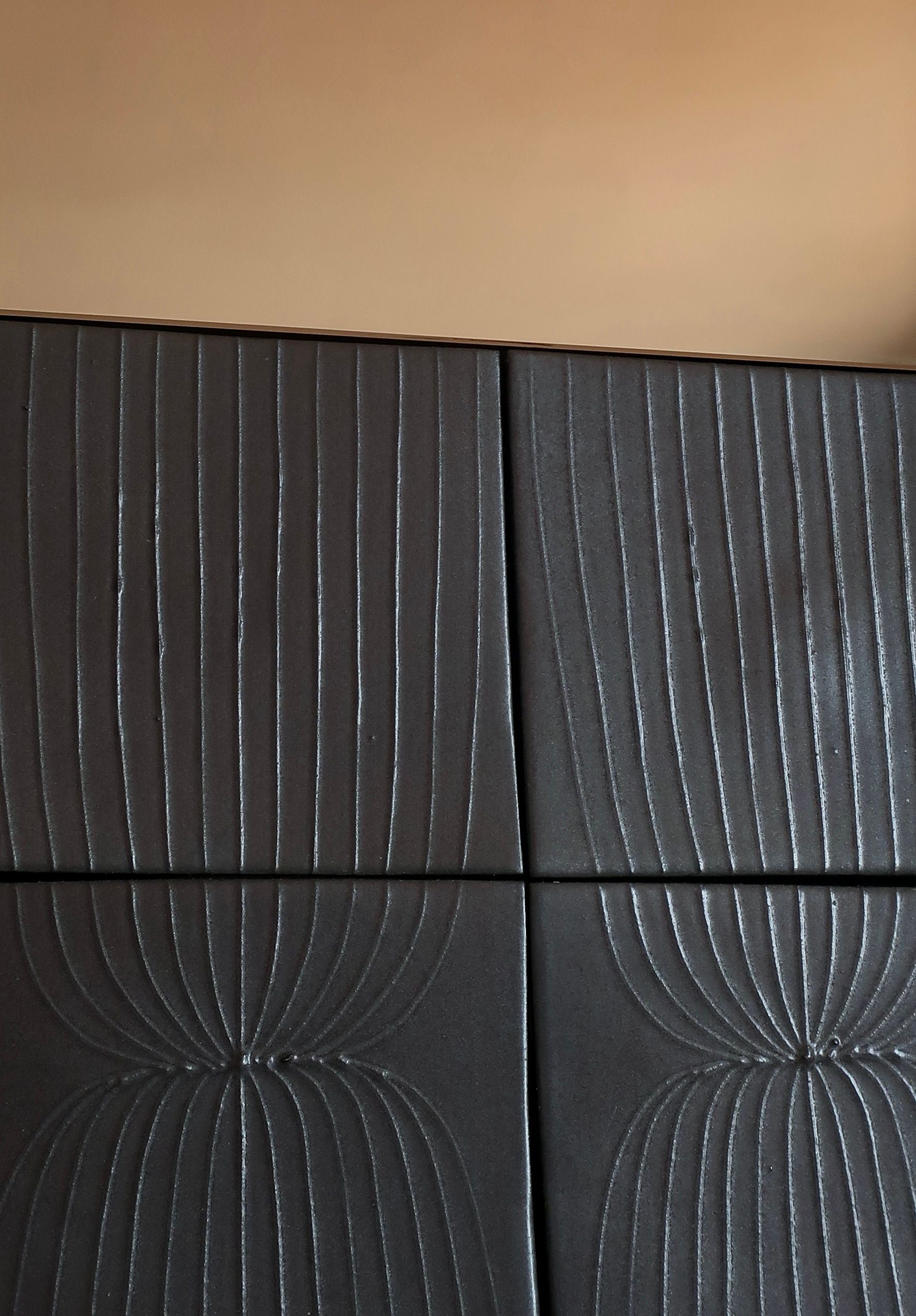 Textured black panels detail of Equis sculpture mirror by ORRE