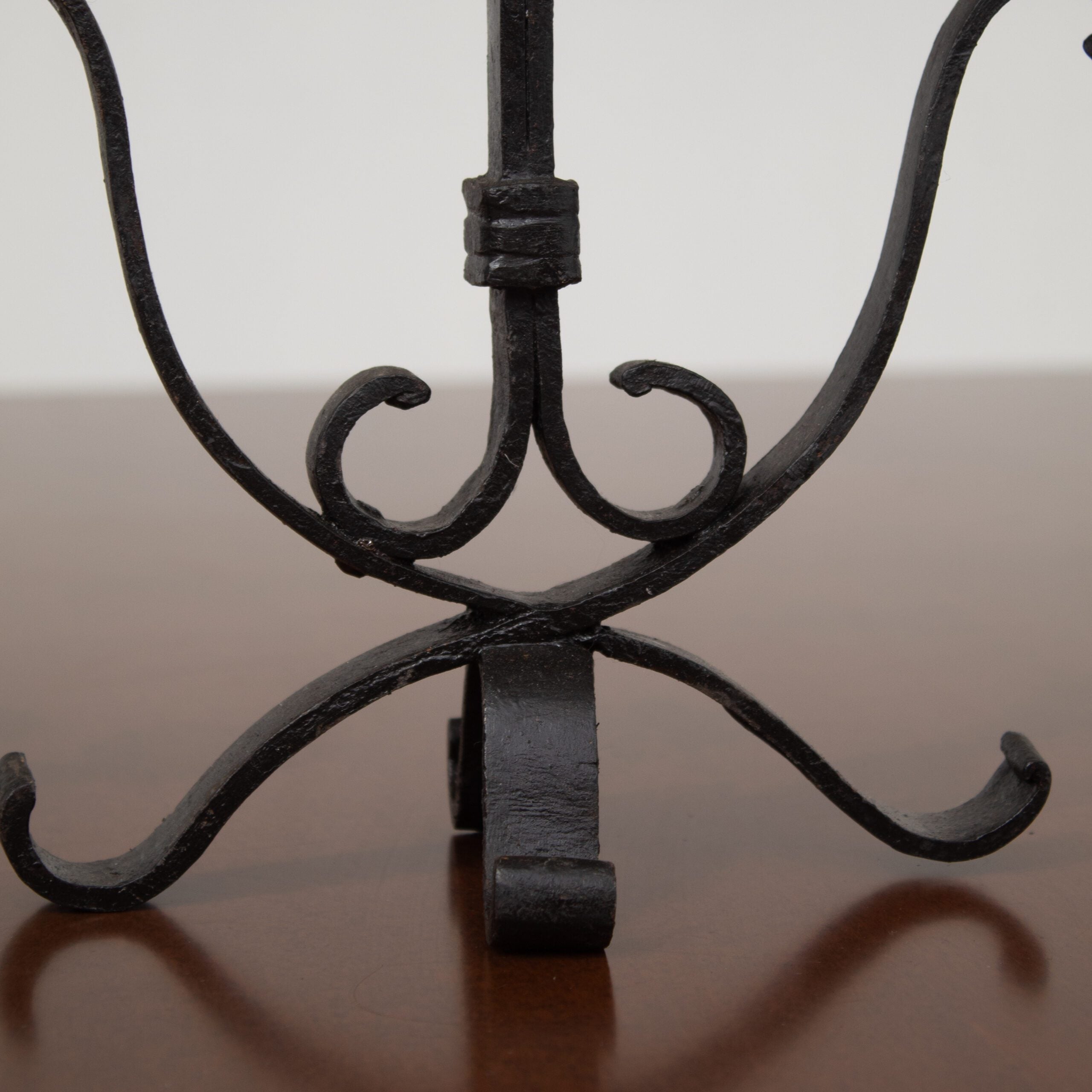 Pair of Brutalist Iron Candleholders with Sculptural Scroll Arms — in context