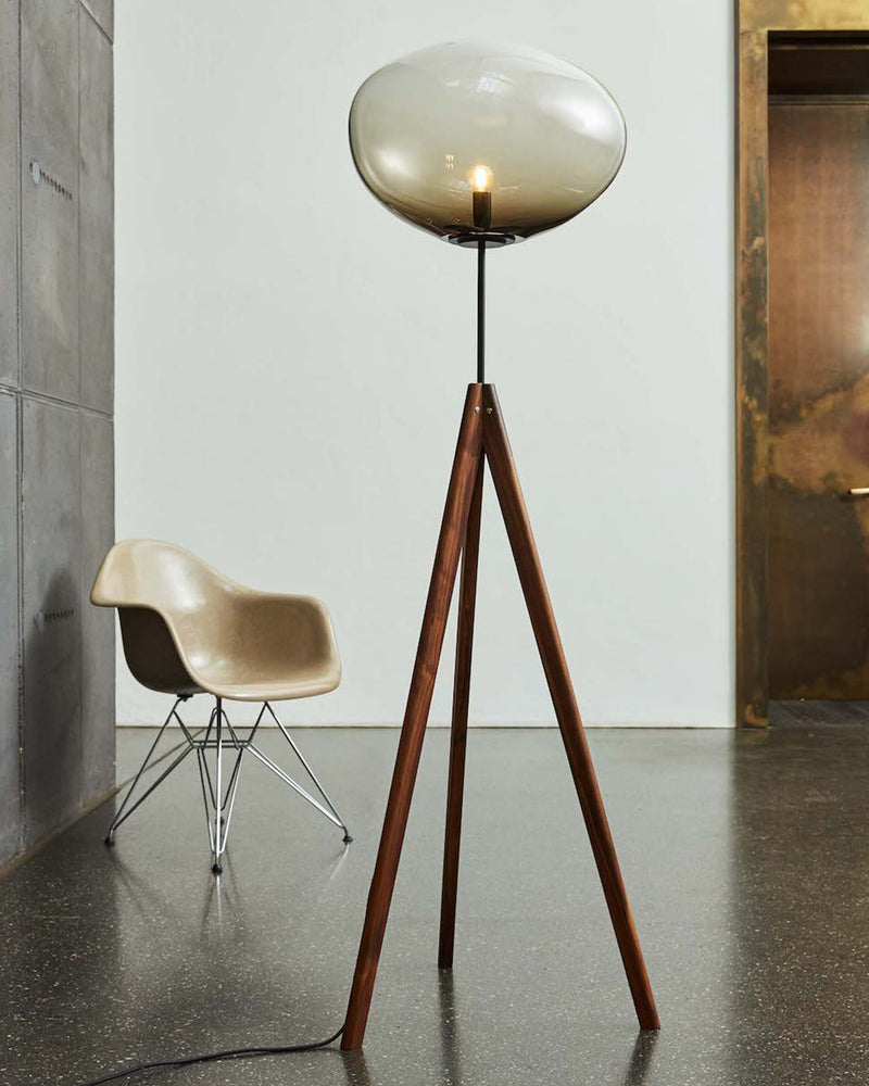 STATIX Floor Lamp — close-up of glass shade and wooden legs