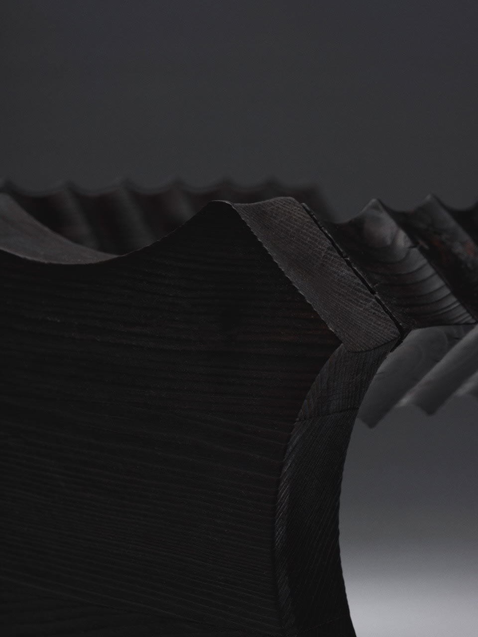 The Spiky Stool — top view of dark wood with textured surface