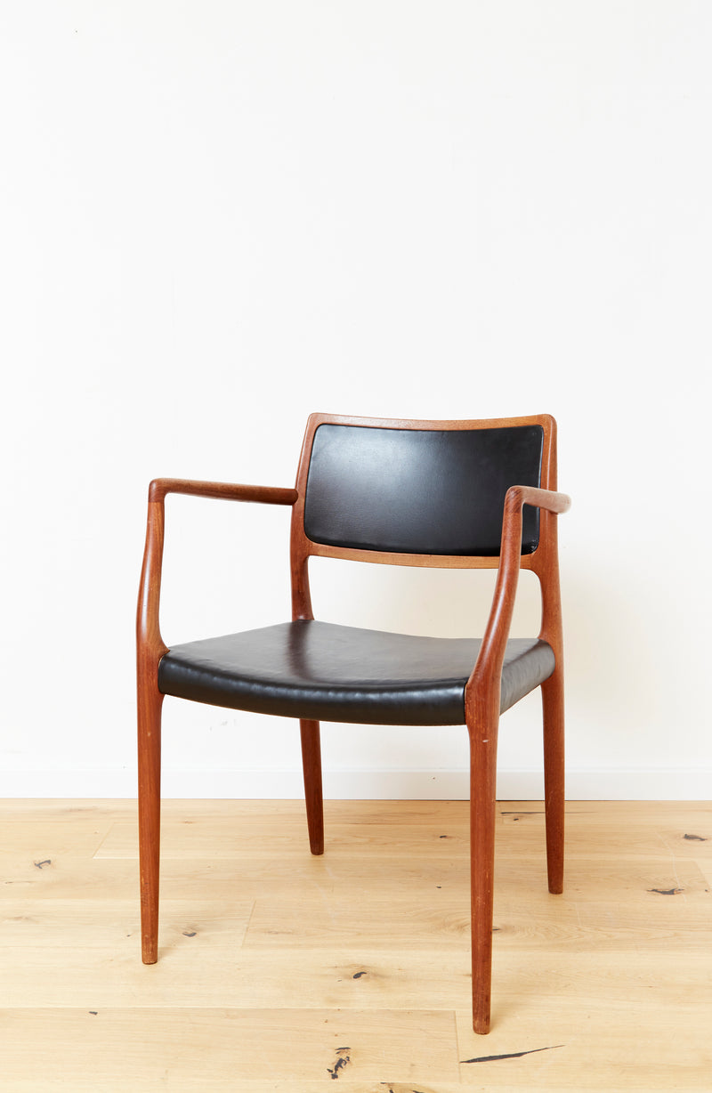 Danish teak armchair with black leather upholstery by Møller
