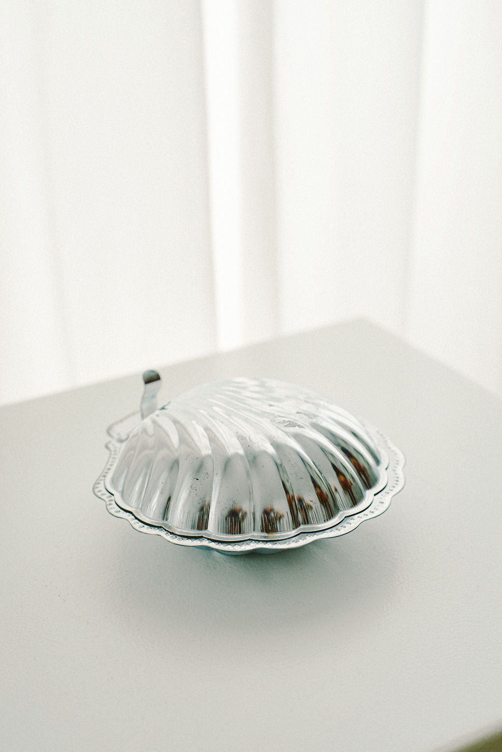 Silver-Plated Shell Butter Dish, Cobalt Blue Insert — side view showing shiny surface