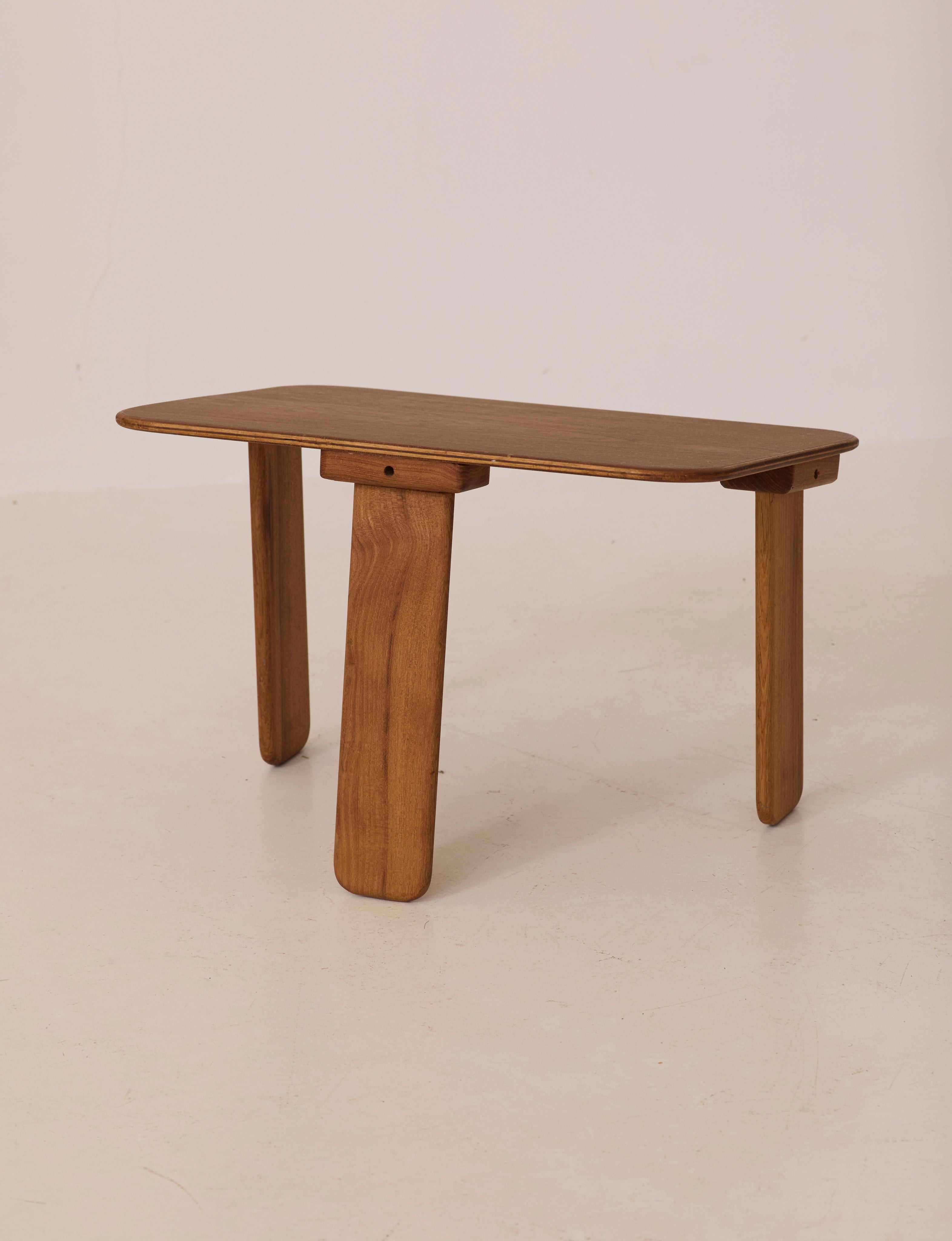 Small dismountable wooden meditation table by Alain Gaubert, France circa 1980 — angled view on neutral background