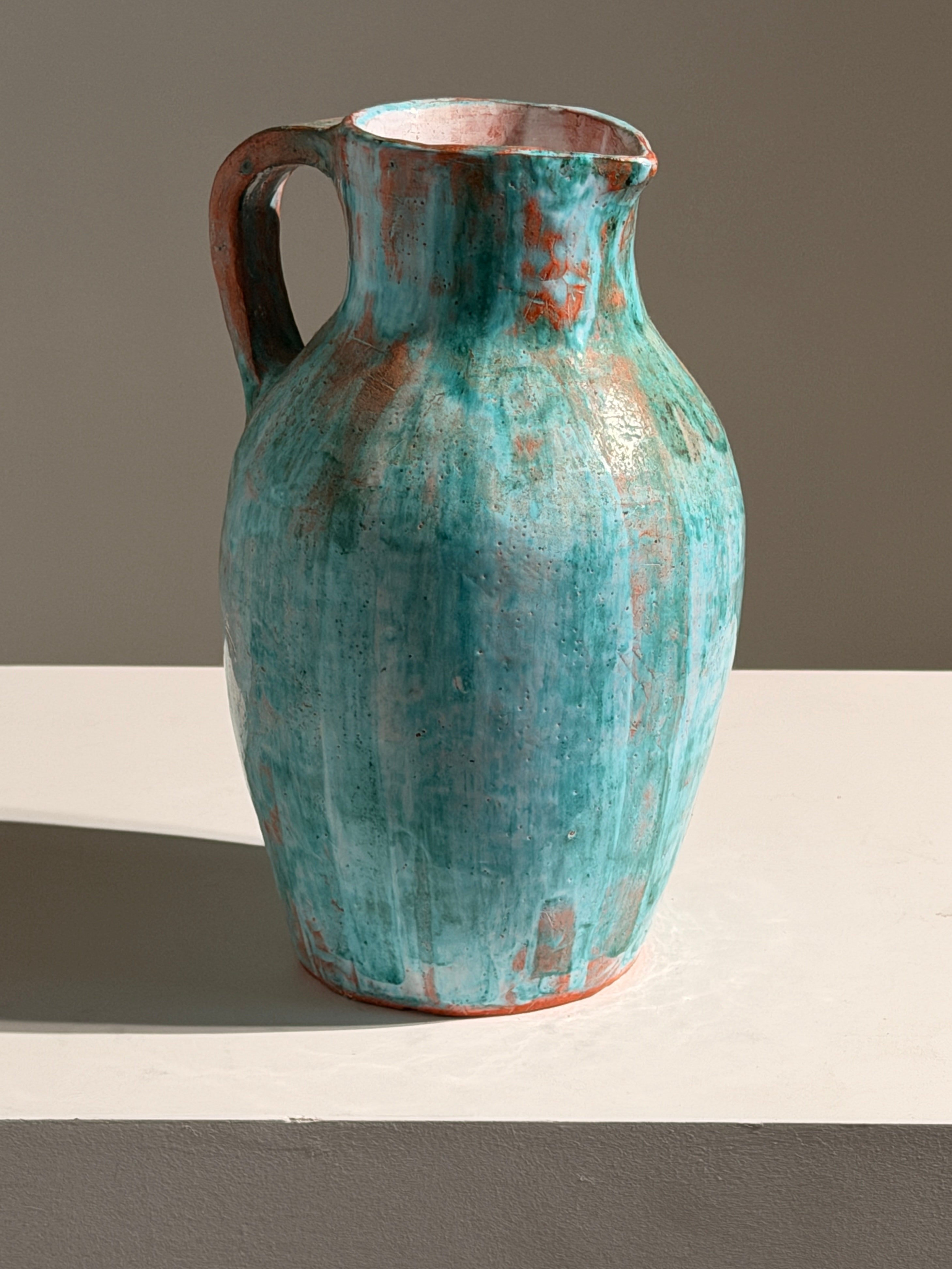 Large pitcher in green glazed earthenware, south of France, circa 1960. — lifestyle setting