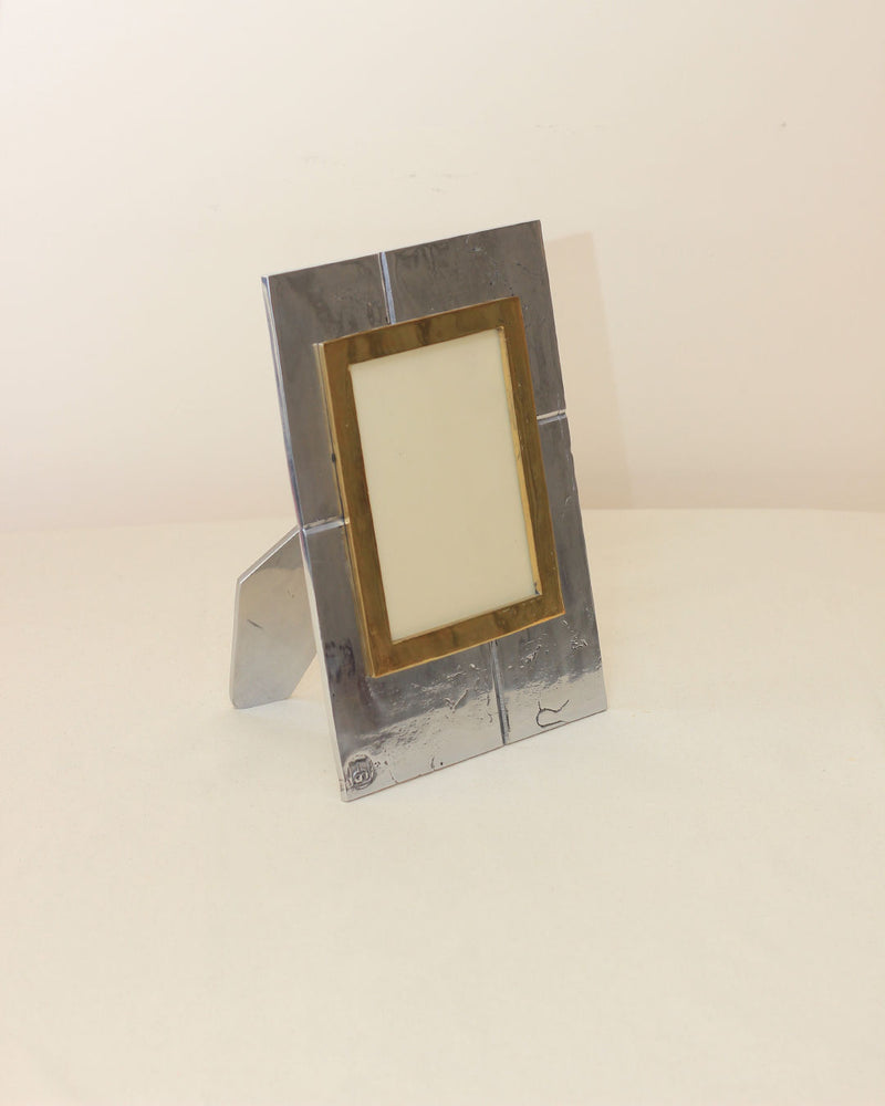 Brutalist Portrait Holder — close-up of metallic frame with brass accent