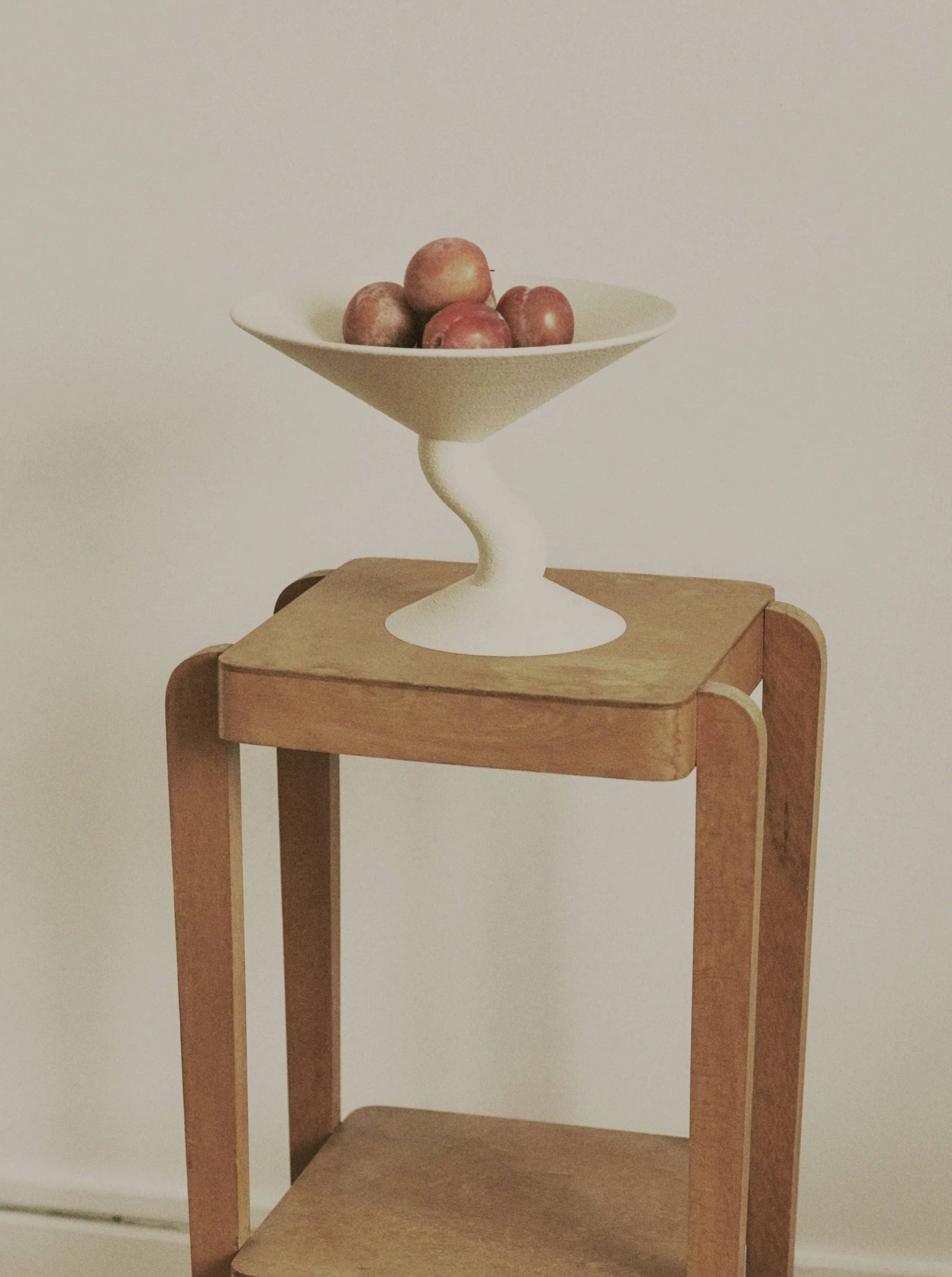 Wavy Fruit Stand — close-up of white ceramic bowl on wooden table