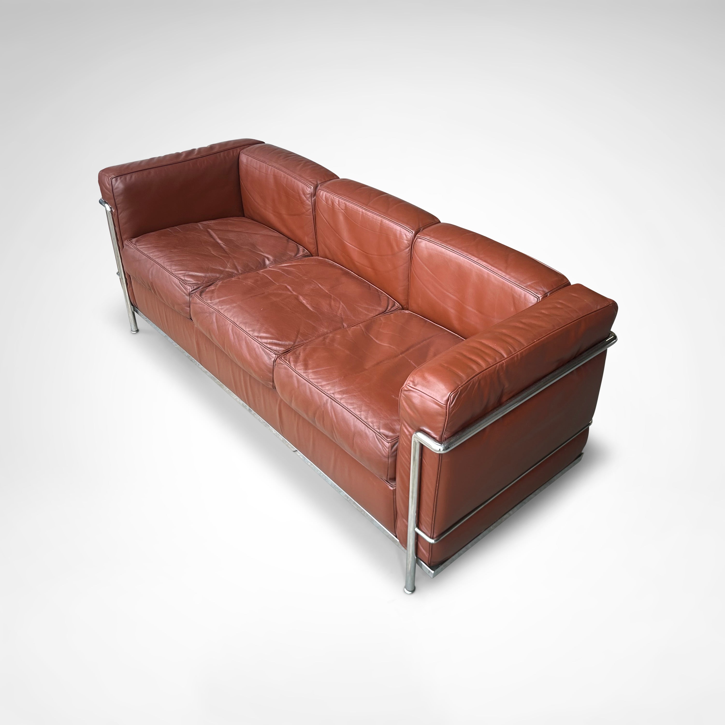 Early production LC2 leather 3-seater sofa by Le Corbusier et al Cassina 1970s — angled view highlighting rich brown leather