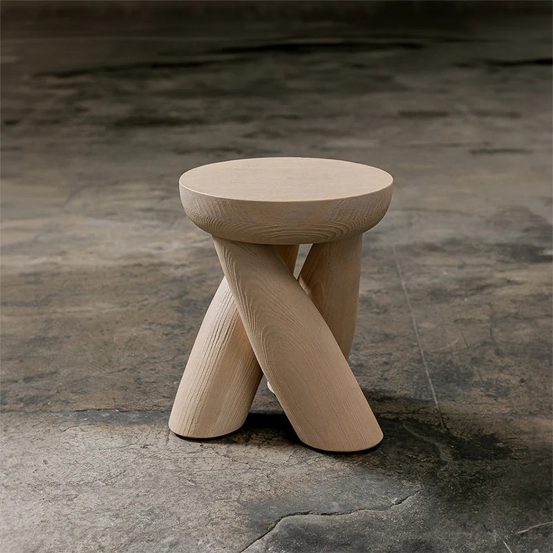ELEMENTOS Set of Stools, sandblasted pine with black finish by Daniel Couttolenc — close-up of rounded top and crossed legs