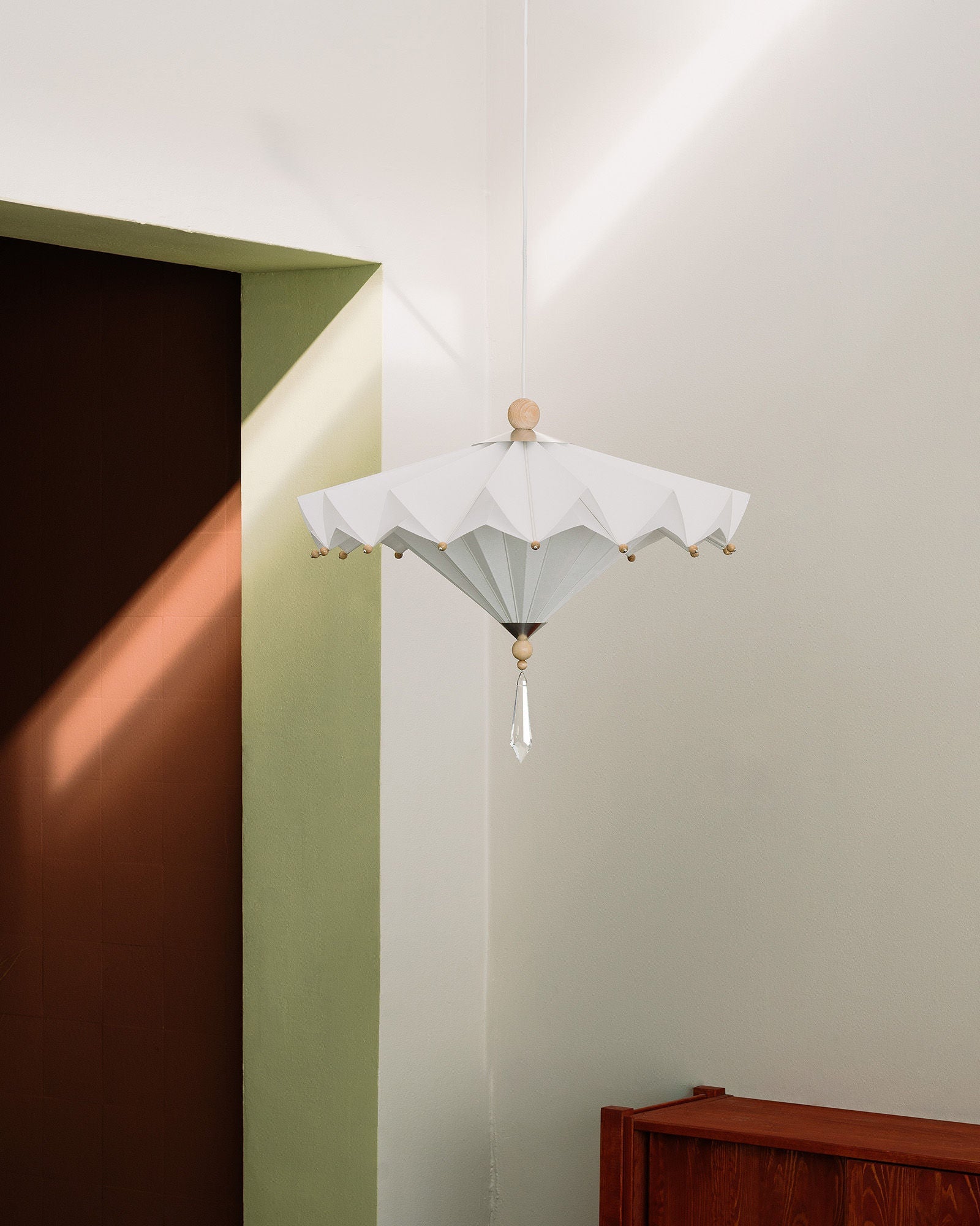 White pleated pendant light with geometric design and crystal drop