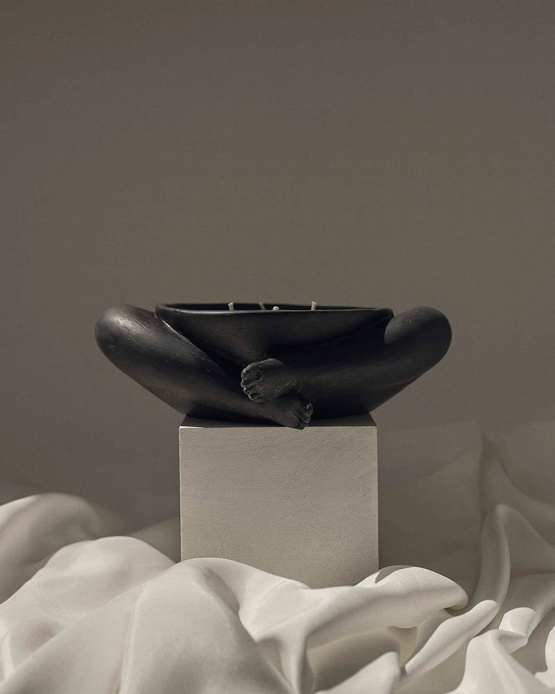 Contemporary Sculptural Candle in Resin and Stone – Biblichor by Marcela Cure — close-up of black resin candle on white fabri