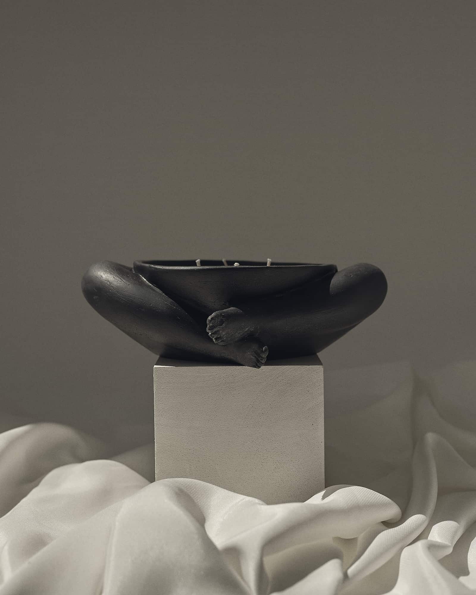 Contemporary Sculptural Candle in Resin and Stone – Biblichor by Marcela Cure — close-up of black resin candle on white fabri