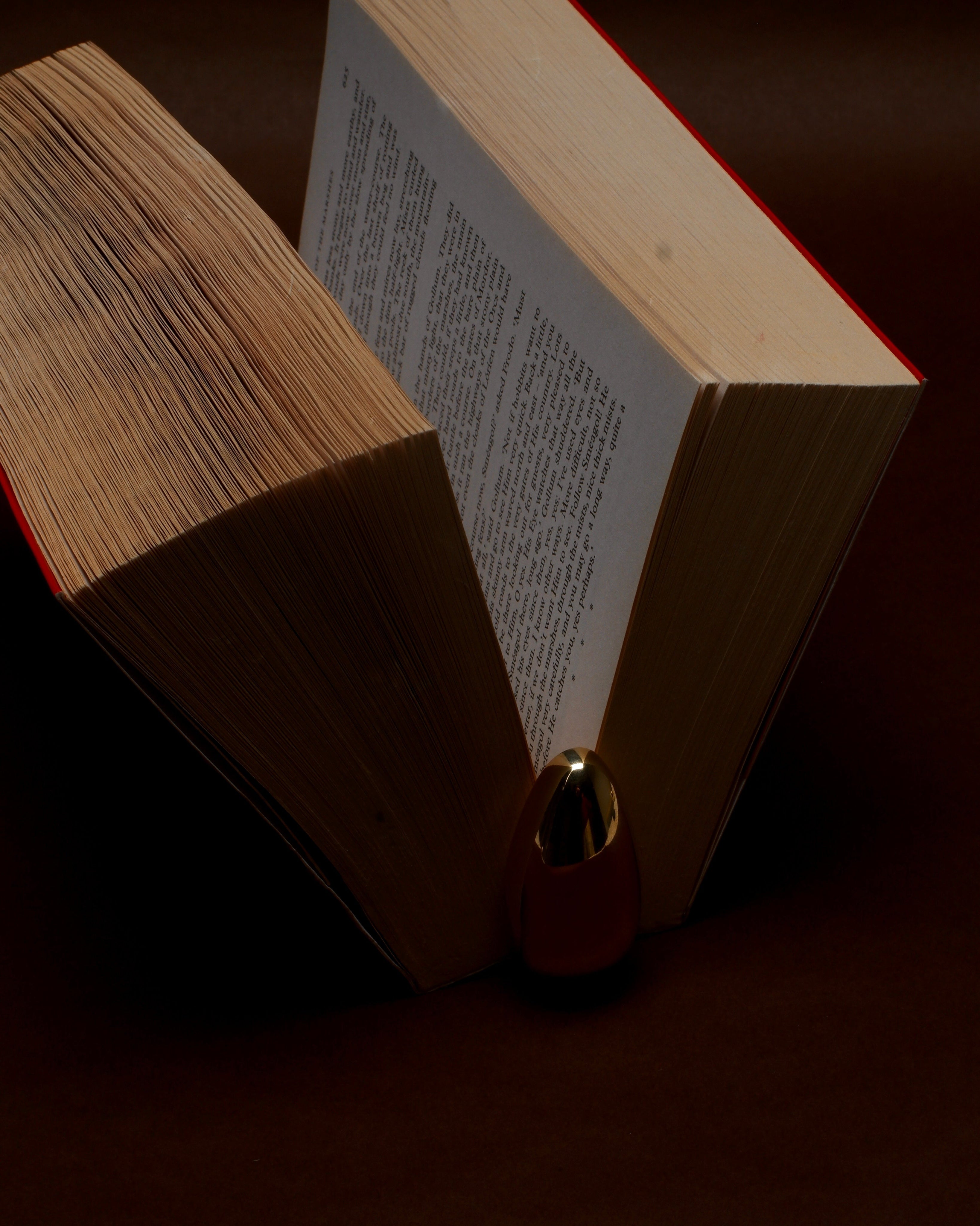 MOMI Bookmark No. 2 — close-up of brass bookmark between book pages