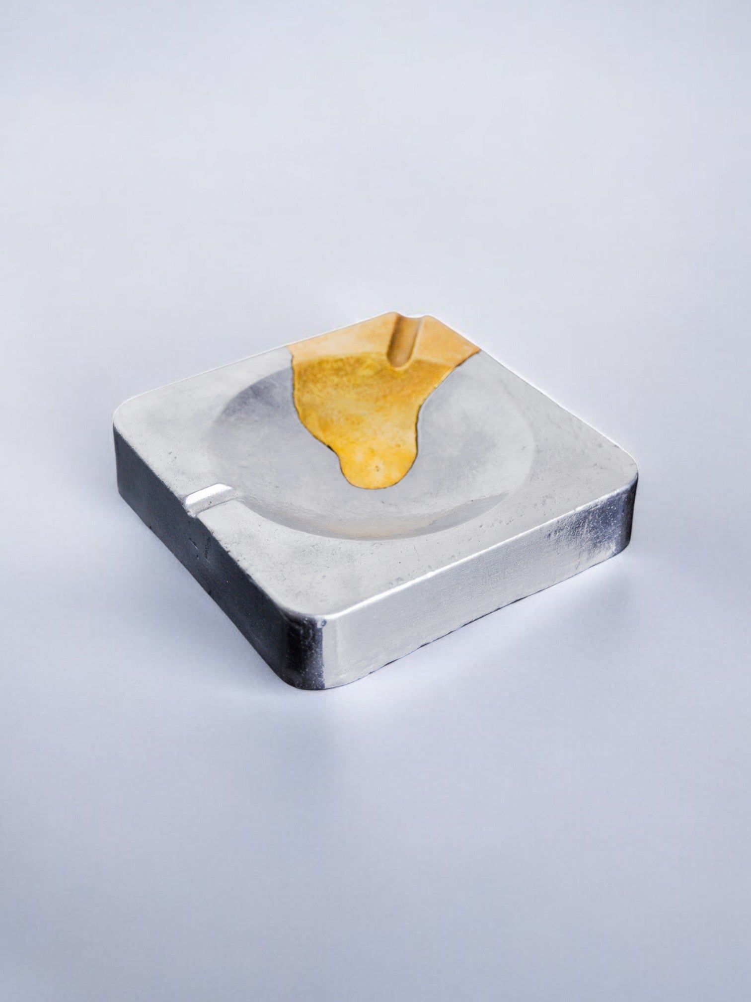 Brutalist ashtray by Art3, brass and aluminum, Spain, 1970 — top view on gray background