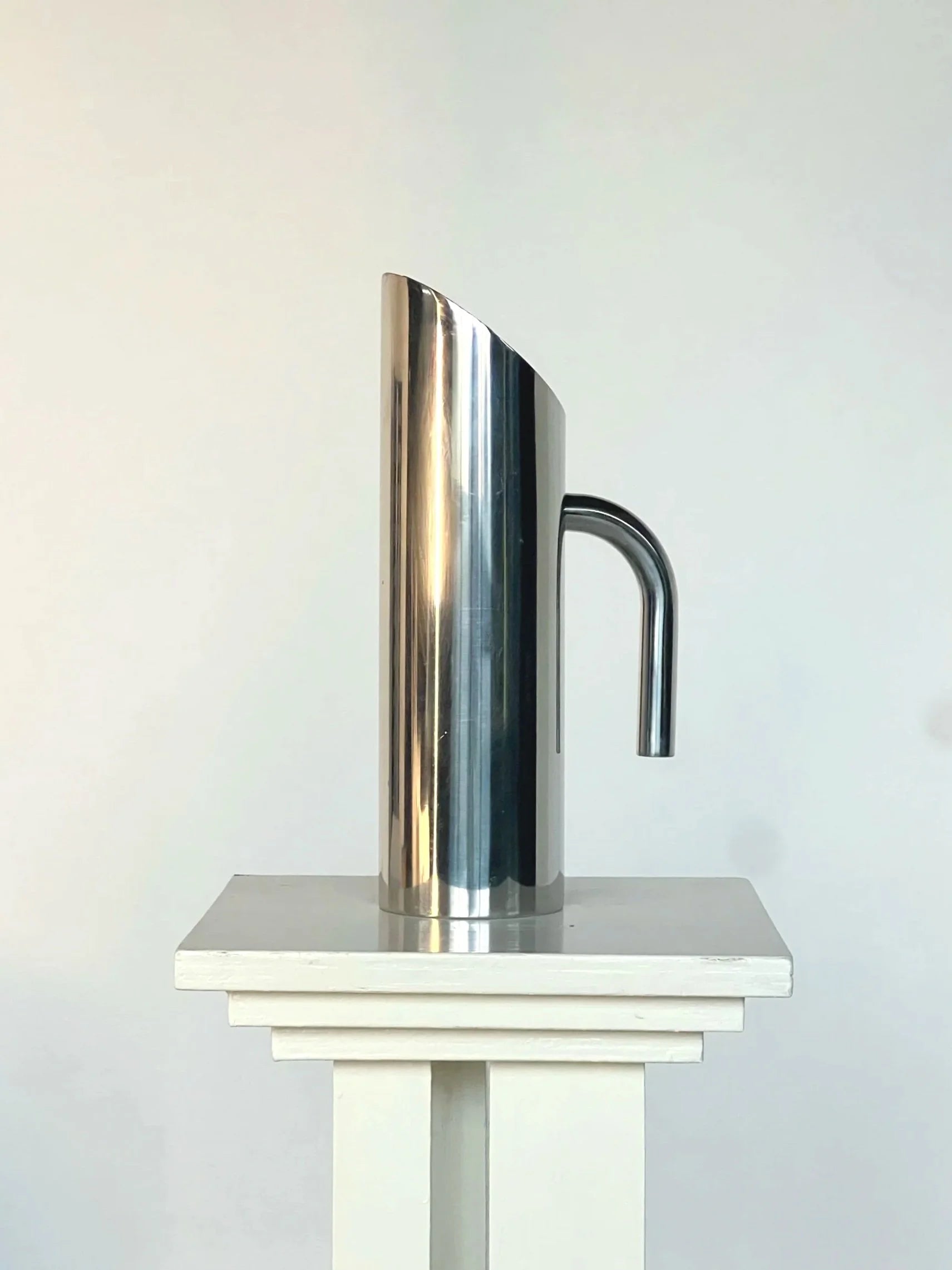 Sculptural Polished Water Jug — side view highlighting polished stainless steel finish