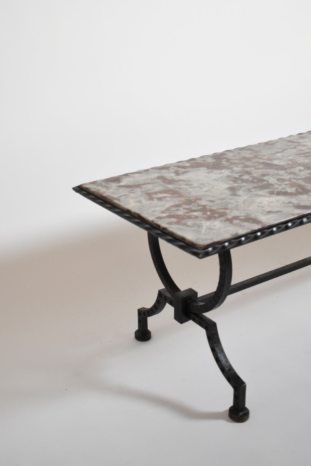 Wrought iron and marble coffee table, France 1940s — angled view highlighting marble top texture
