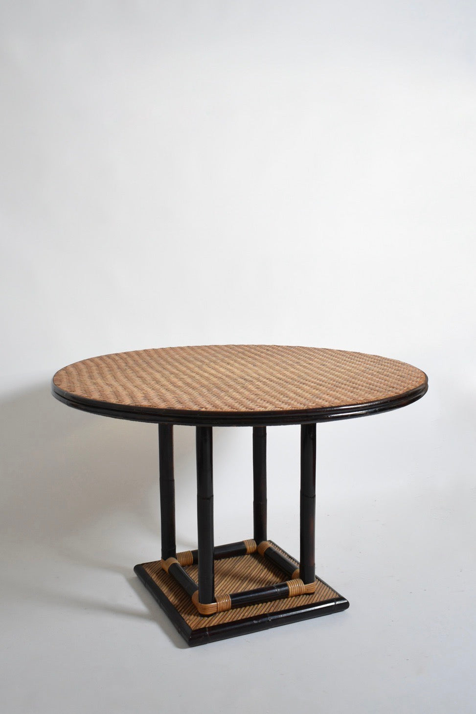 Bicolor round rattan dining table — side angle