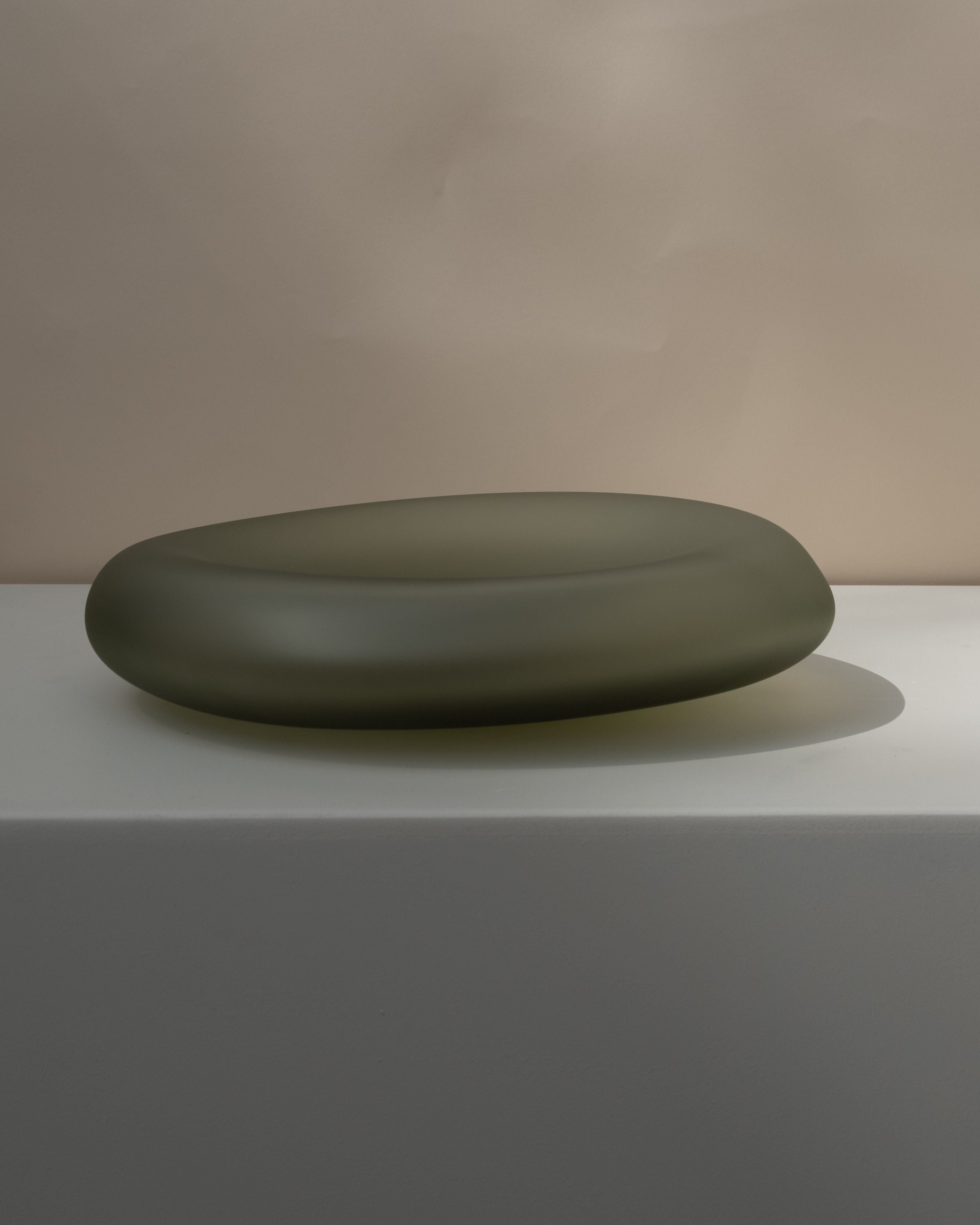 Glass Sculptures SEAGLASS | color smoke green — side angle on white pedestal