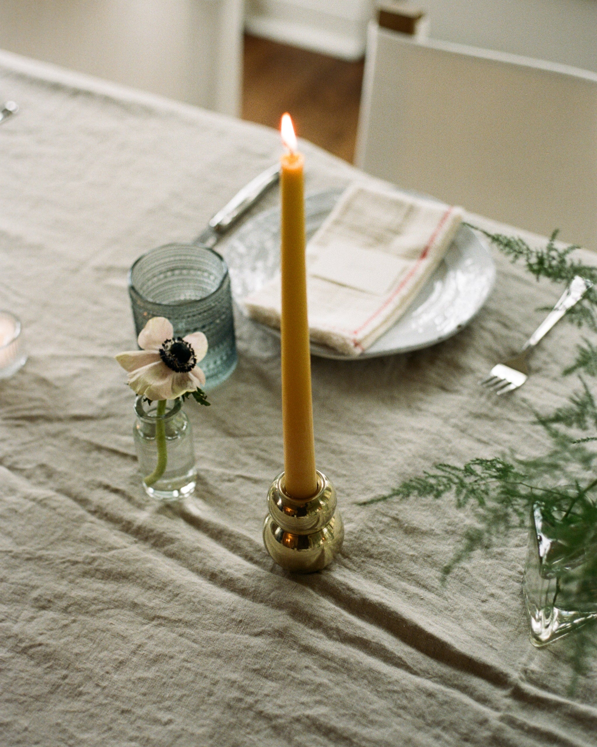 ANJOU Candleholder — side view with yellow candle on dining table