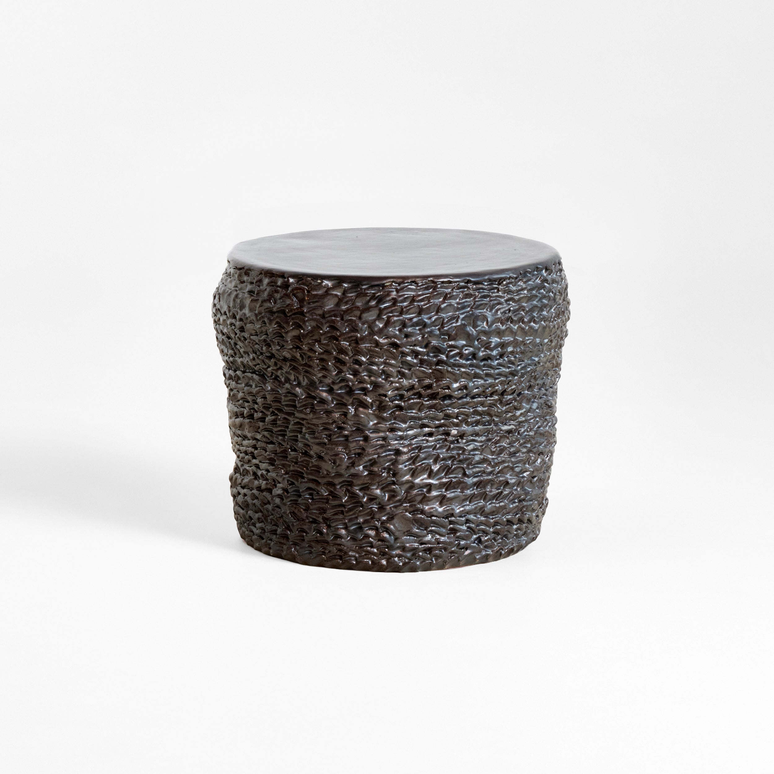 Casa Ceramic Side Table — close-up of textured dark ceramic surface