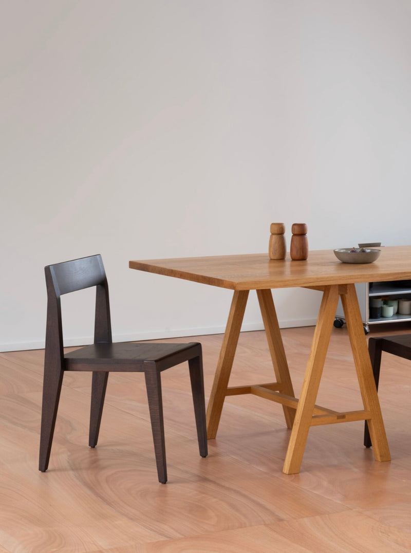 Chair - Ed. Espresso - Oak — side view of chair beside wooden table