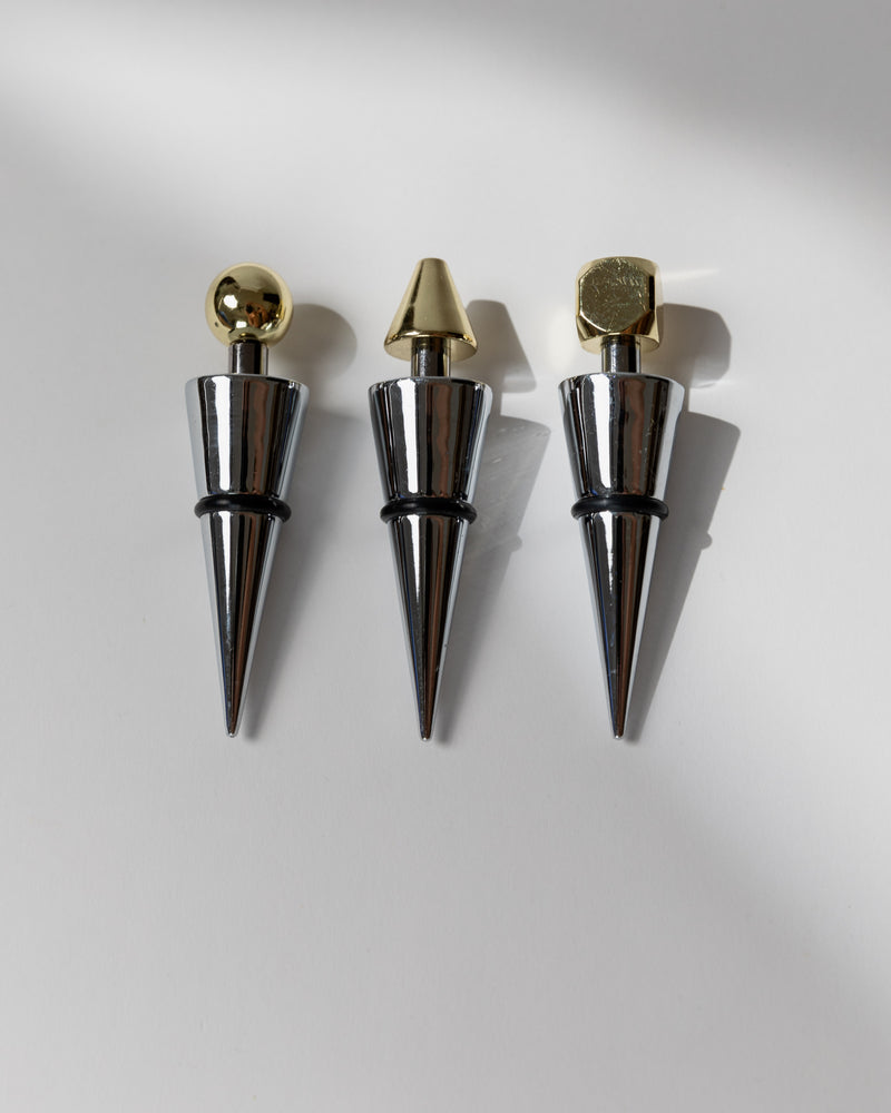 Set of three vintage Italian metal bottle stoppers with gold geometric tops