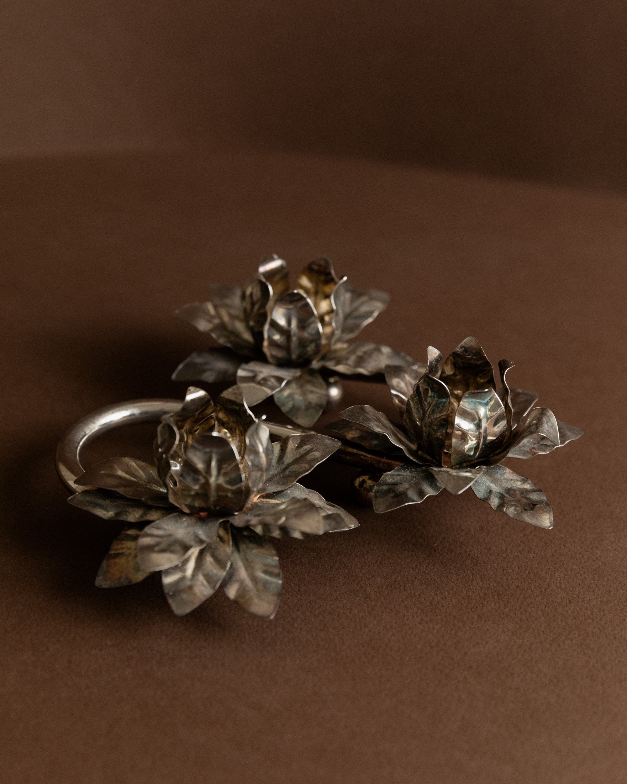 Silver Plated Vintage Candleholders — top view of floral design on brown backdrop