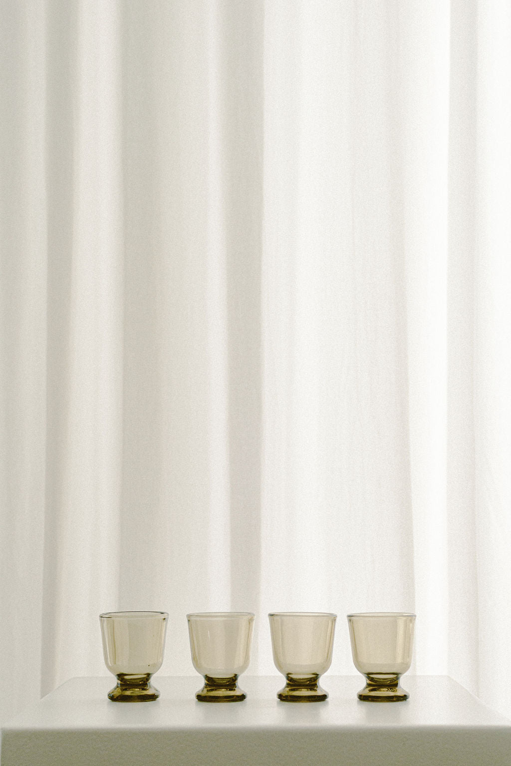 Vintage Smoked Shot Glasses — close-up on glass with brass bases