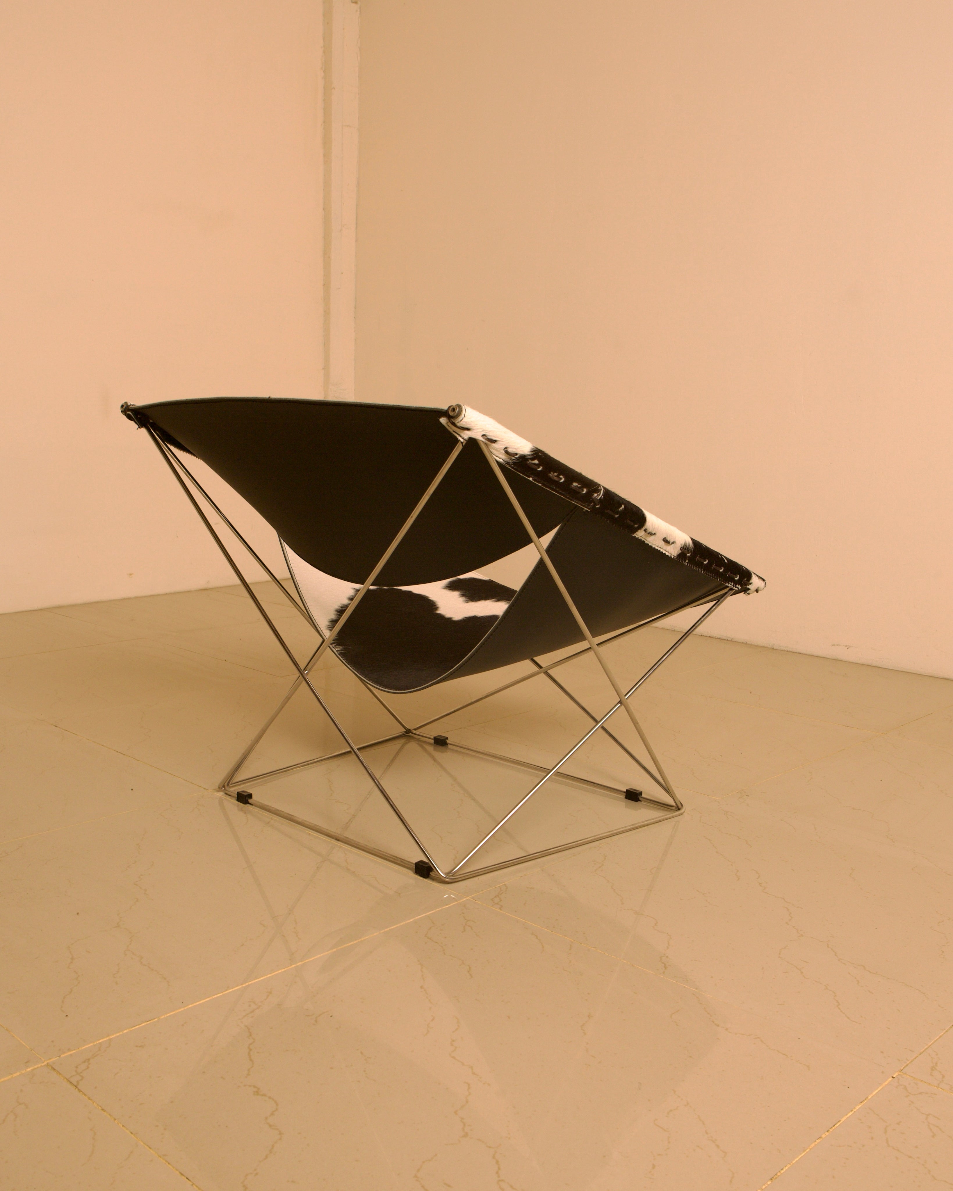 F675 "Butterfly" Cowhide Armchair by Pierre Paulin for Artifort 00's — angled view highlighting cowhide material and metal fr
