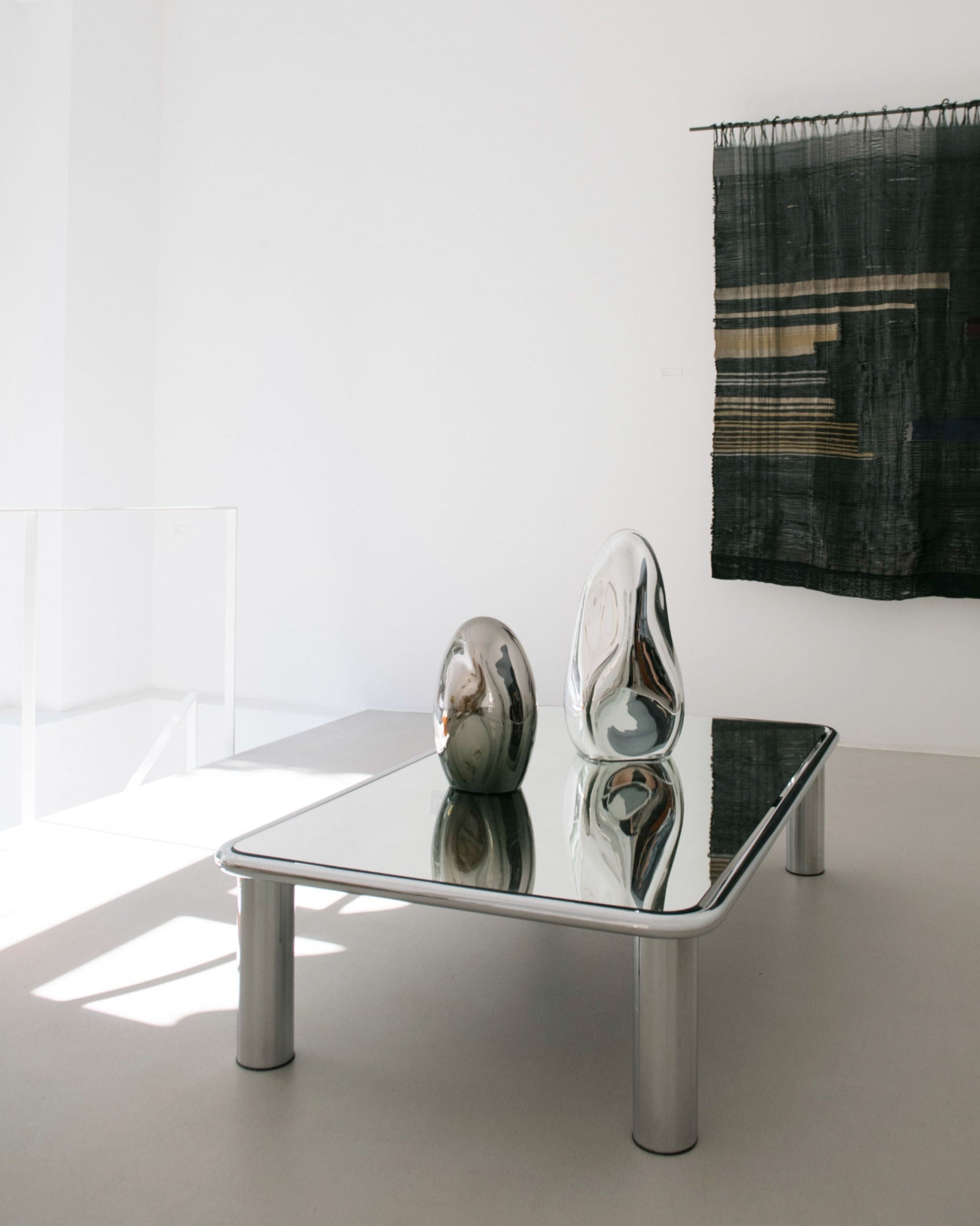 Standing Glass Sculpture - Contemporary Mirror Collection — top view of mirrored sculptures on glass table