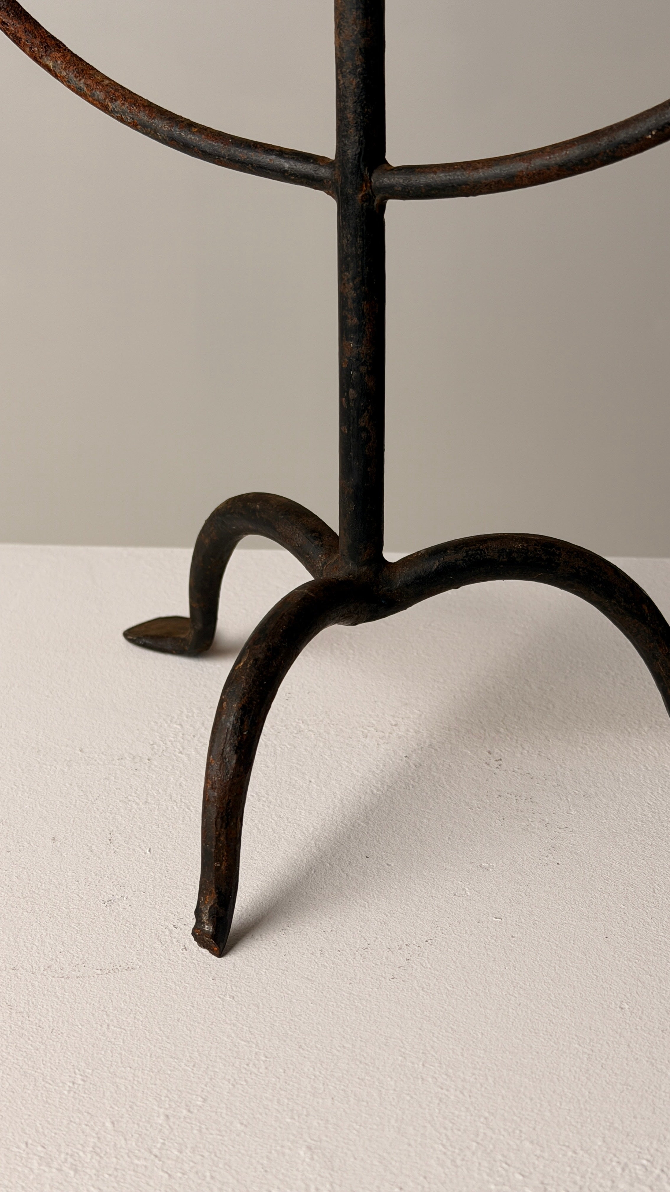 Wrought Iron Candelabrum, France, early 20th century — close-up of base on textured surface