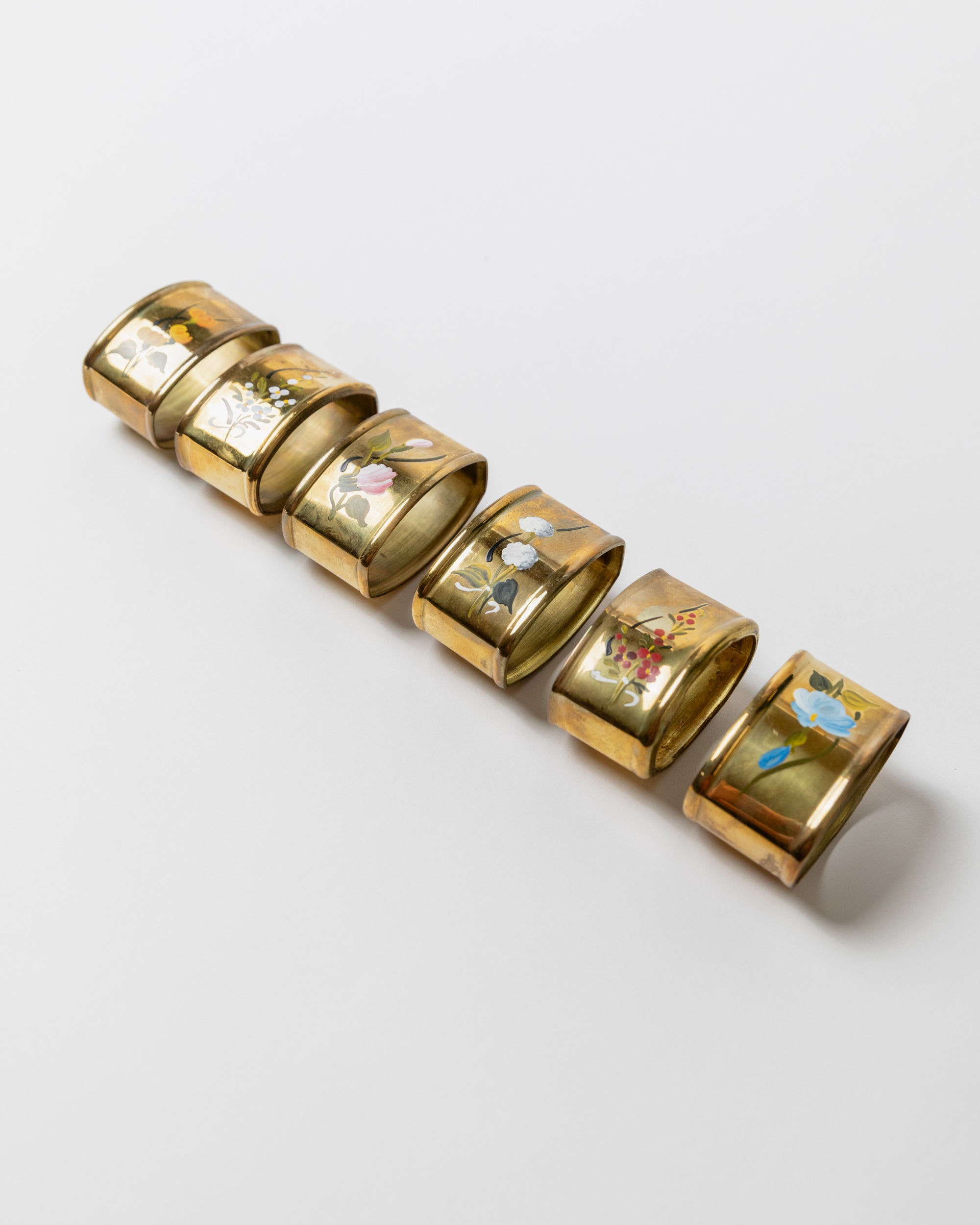 Set of six vintage brass napkin rings with floral motifs, Italy 1940s
