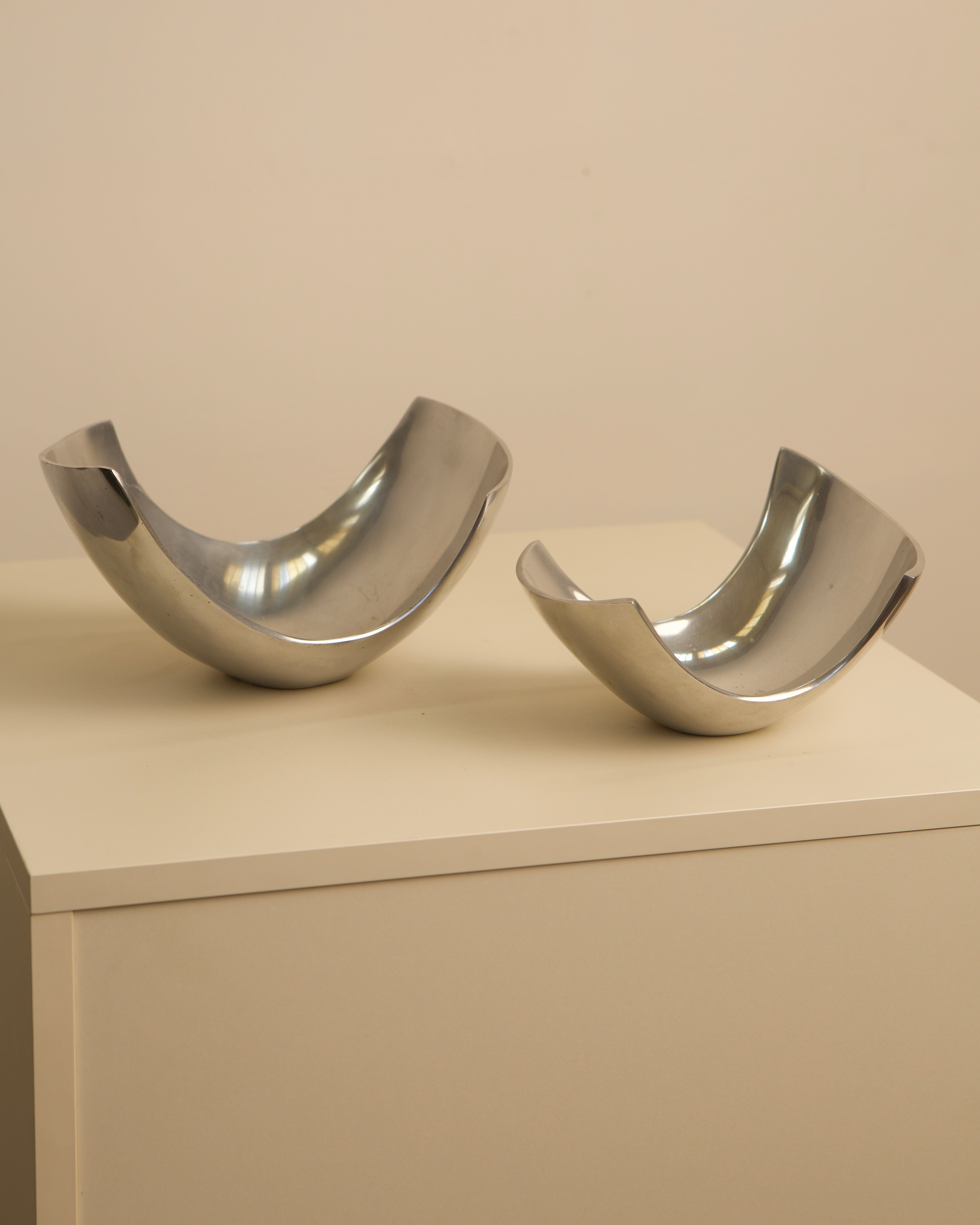 Polished steel Italian fruit baskets pair displayed on pedestal