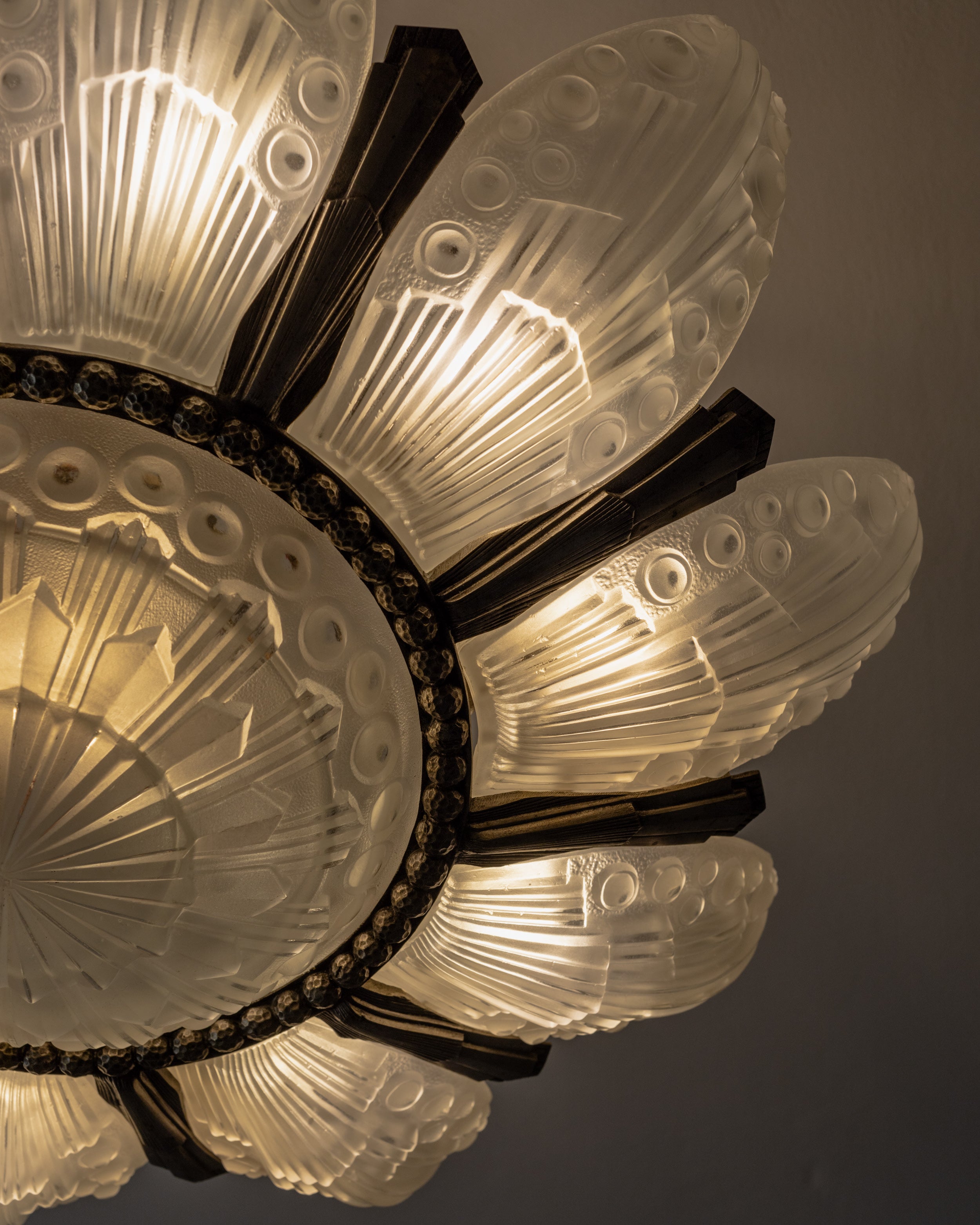 Art Deco chandelier glass shell details with illuminated ridges