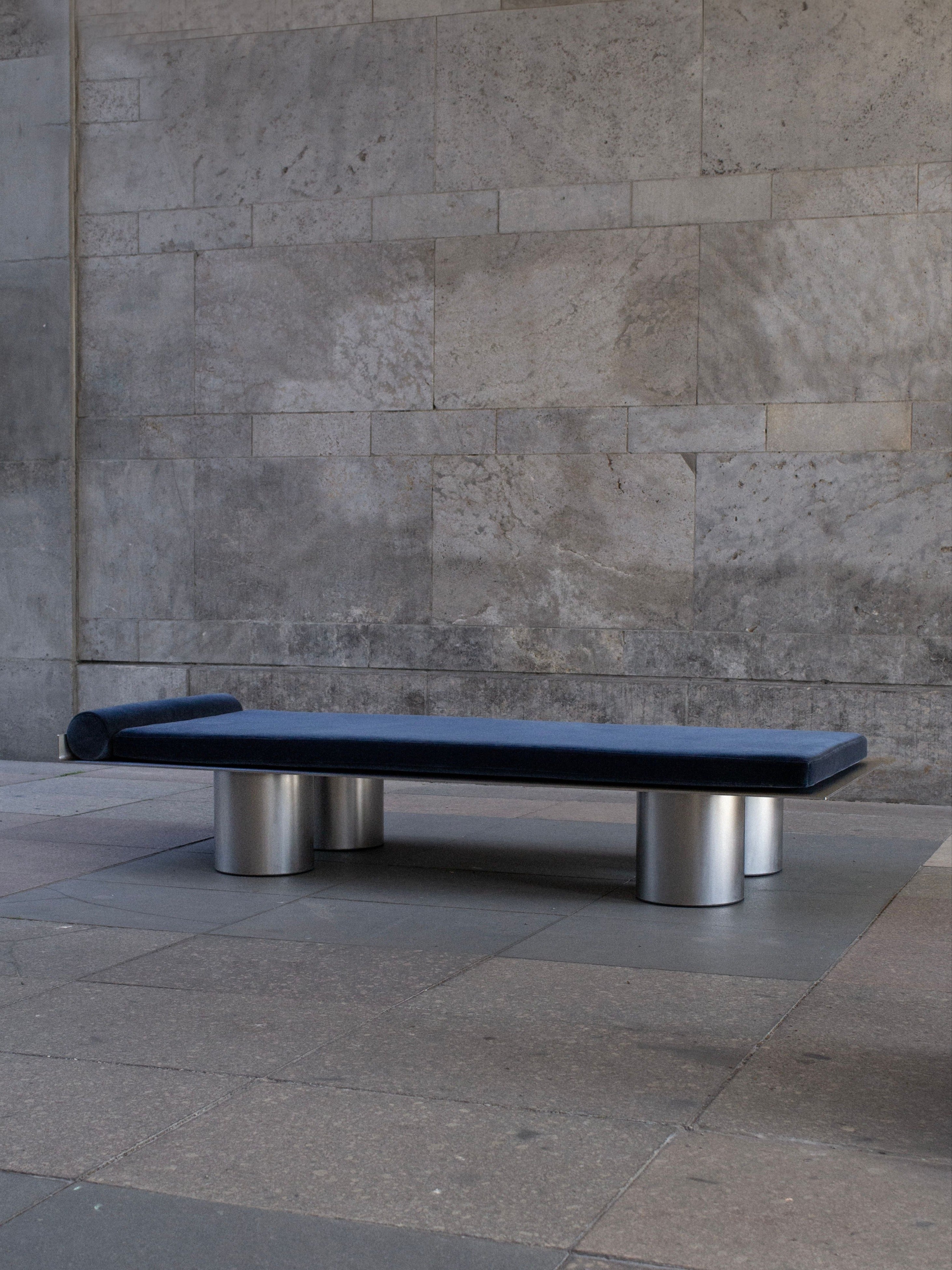 Monteverdi Daybed — side angle showing blue upholstery and metal legs