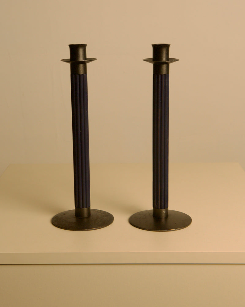 Pair of Swedish Midnight Blue Metal and Wood Candleholders c. 1960 — close-up of candleholders on neutral background