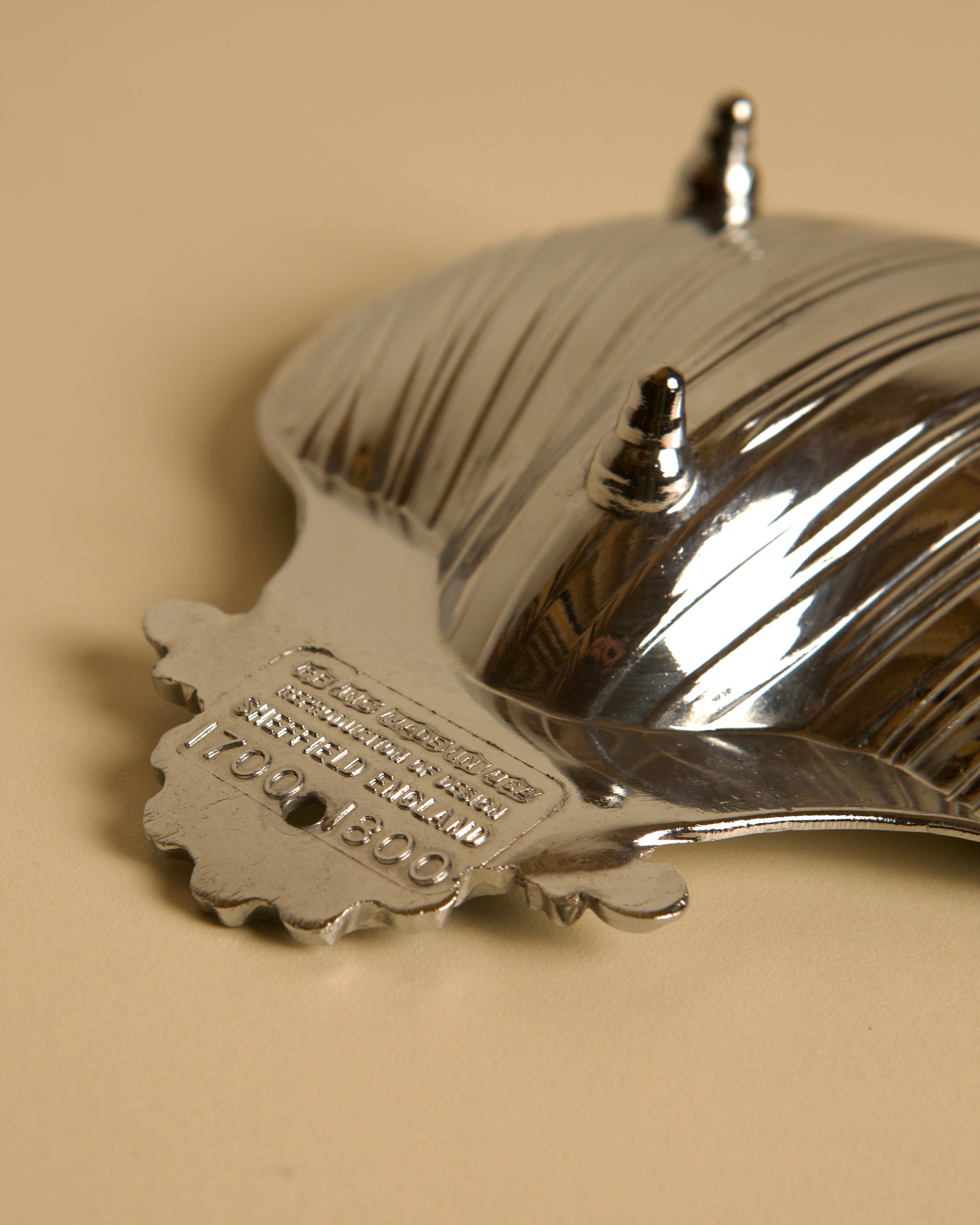Silver-plated shell dish detail showing engraved maker's mark