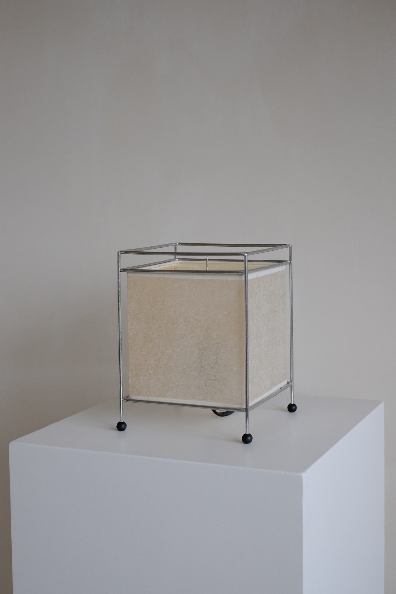 Japanese Rice Paper Table Lamp — side angle on white pedestal