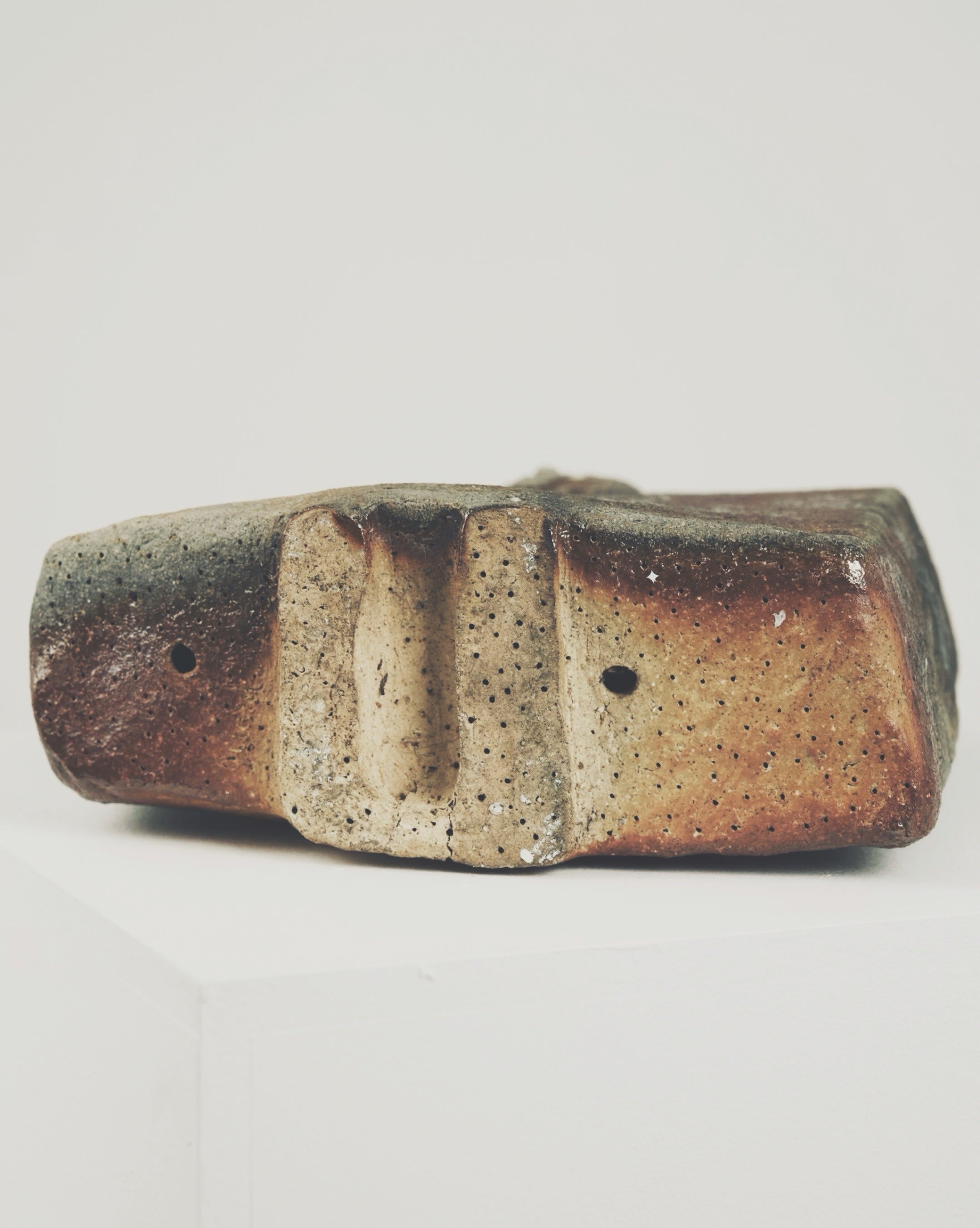 Wood-fired ceramic bottle with earth-toned glazed finish by Brossard