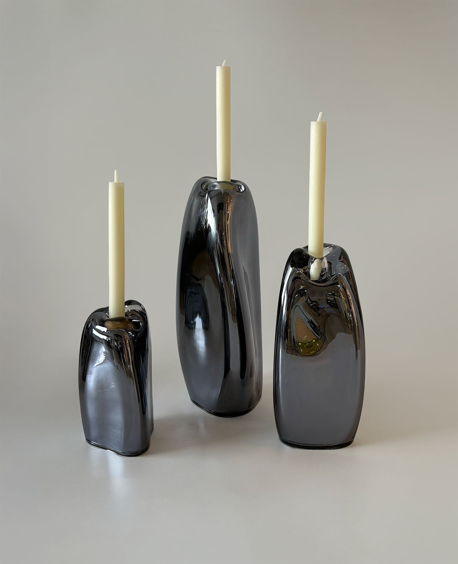 Lumos Smoke Candle Holders — close-up of glossy black glass surface