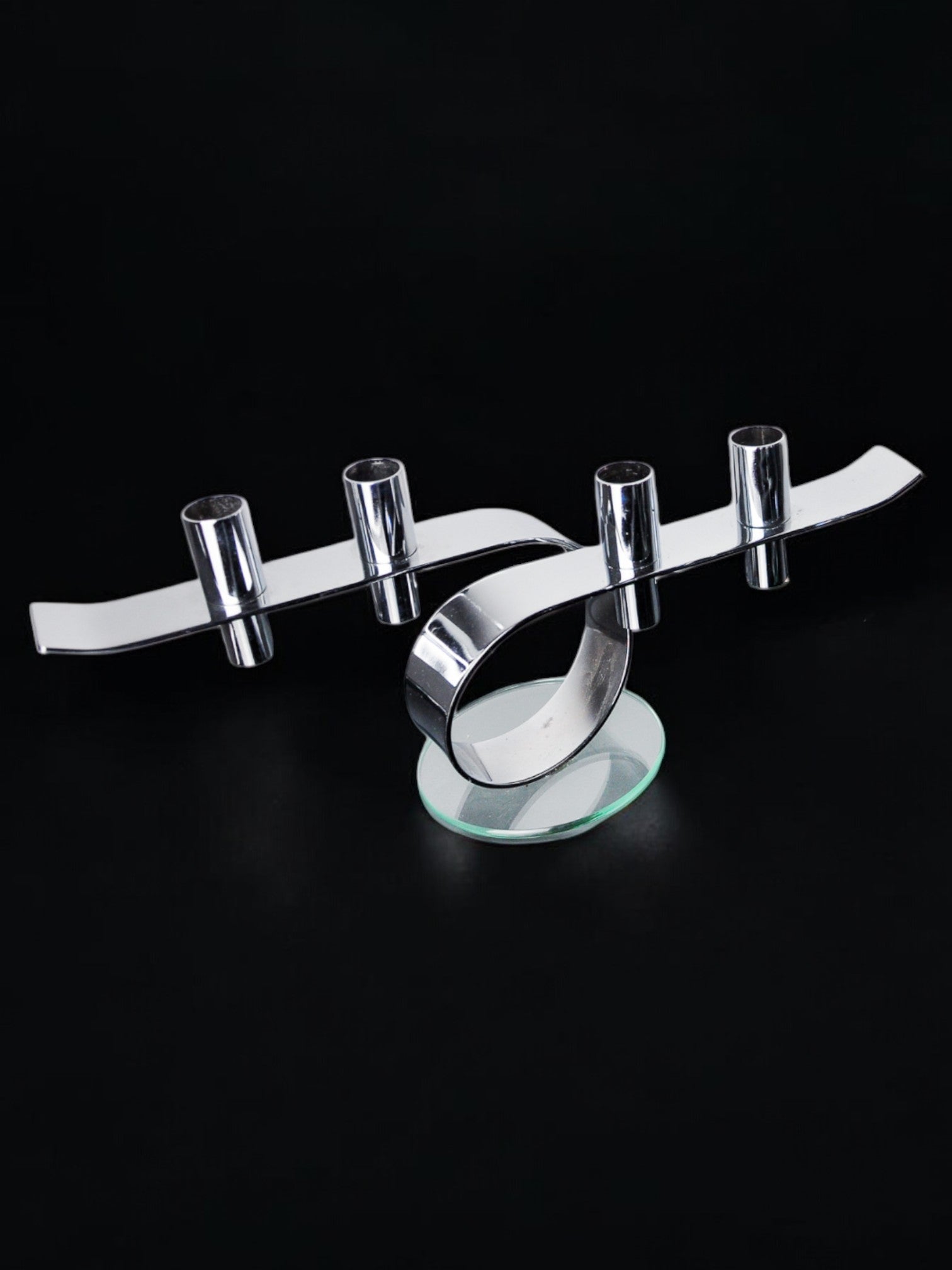 Space-age 4-flame candlestick, glass and metal, Germany, 1980 — side angle on black background
