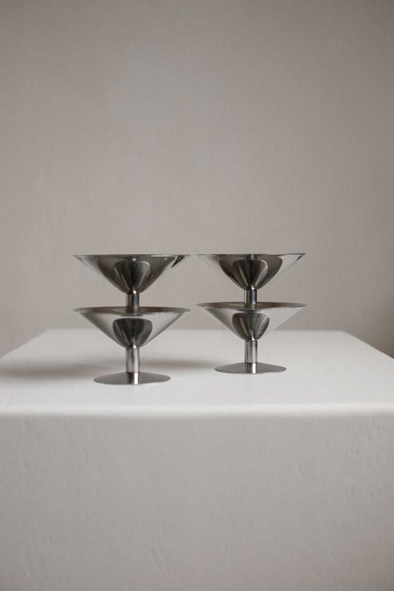 Set of Four Ice Coupes — close-up of polished metal surface on white pedestal