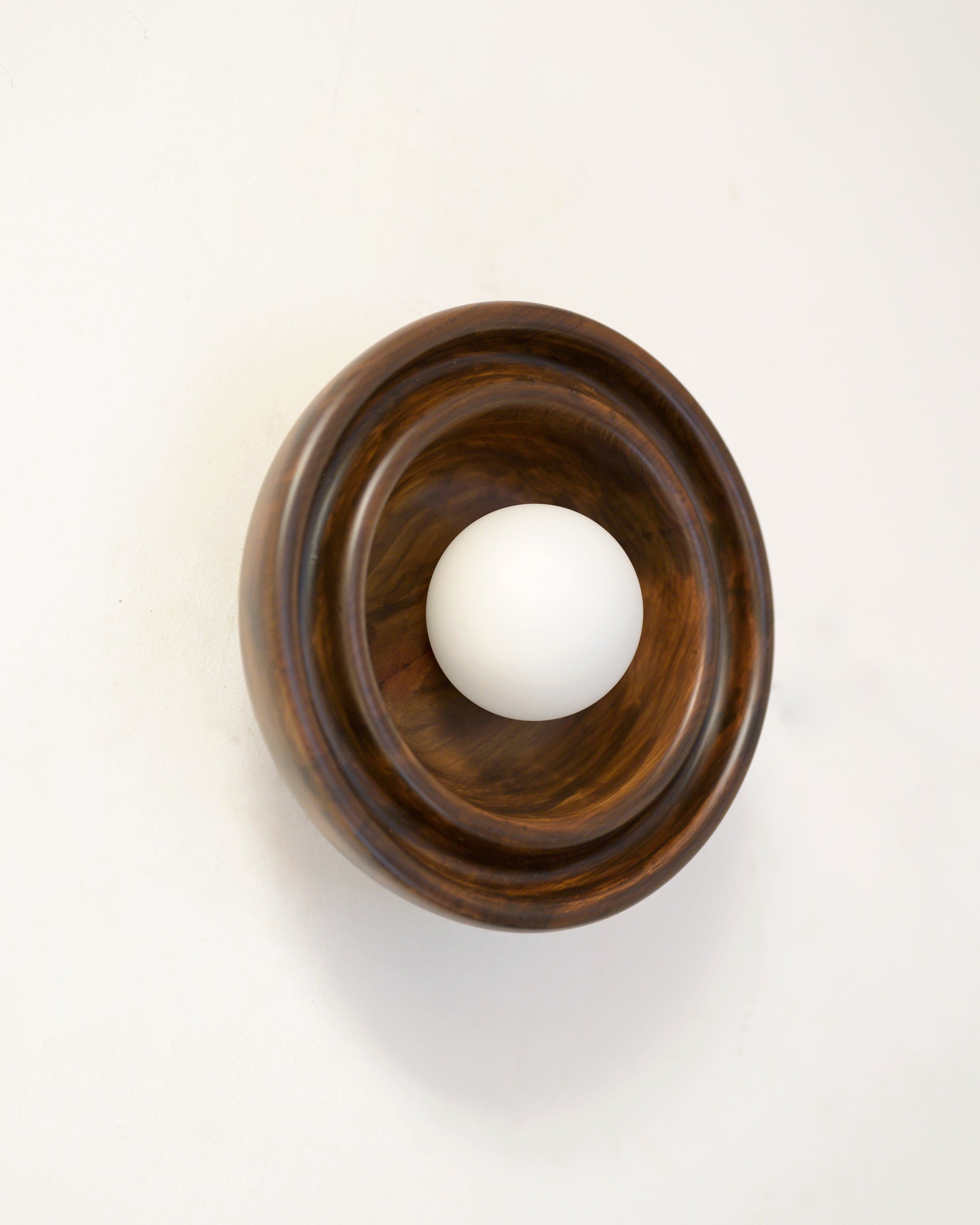 Discus XS Wall Light — mounted on wall with wooden base