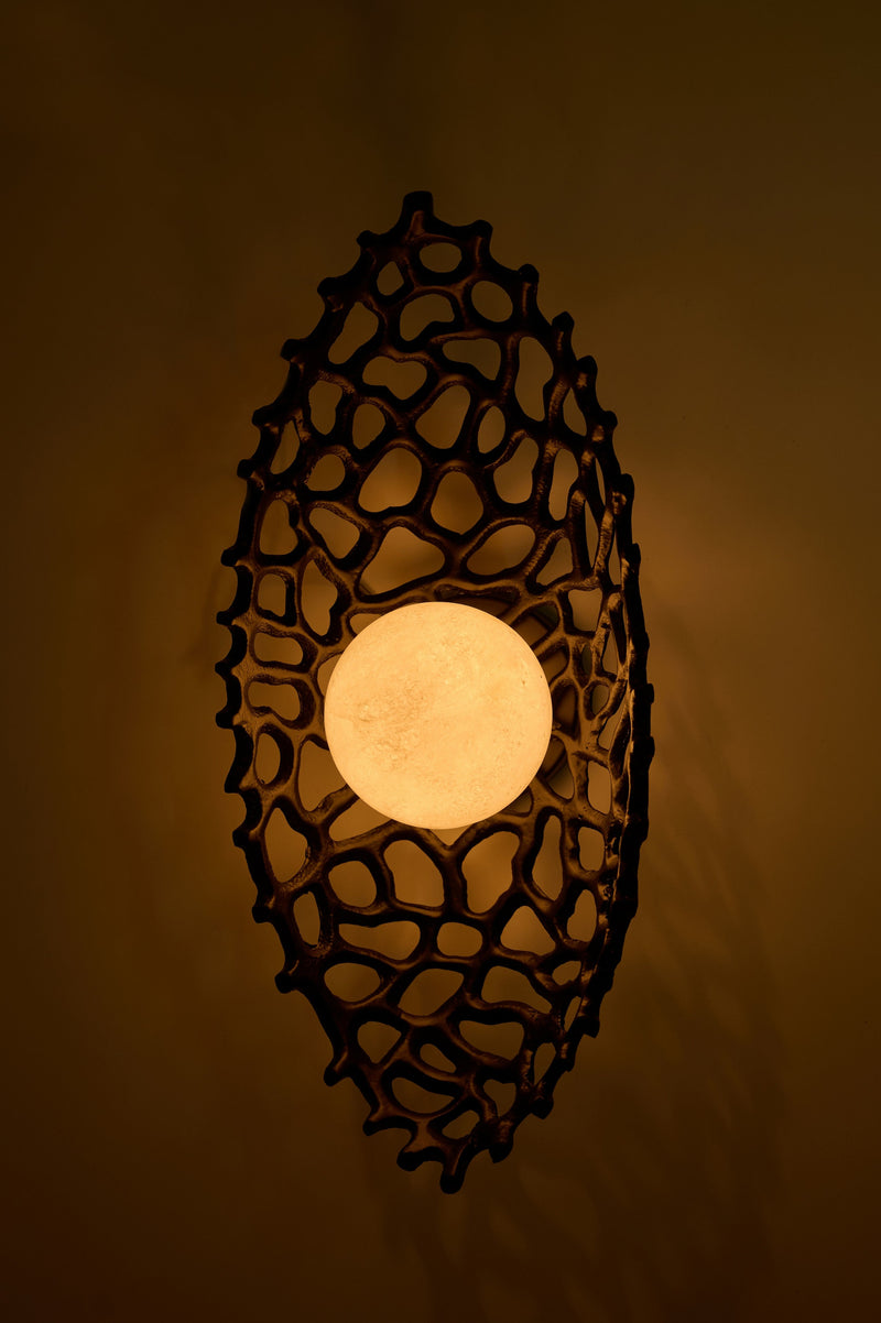 Ajna Sconce — overhead view of textured black metal design