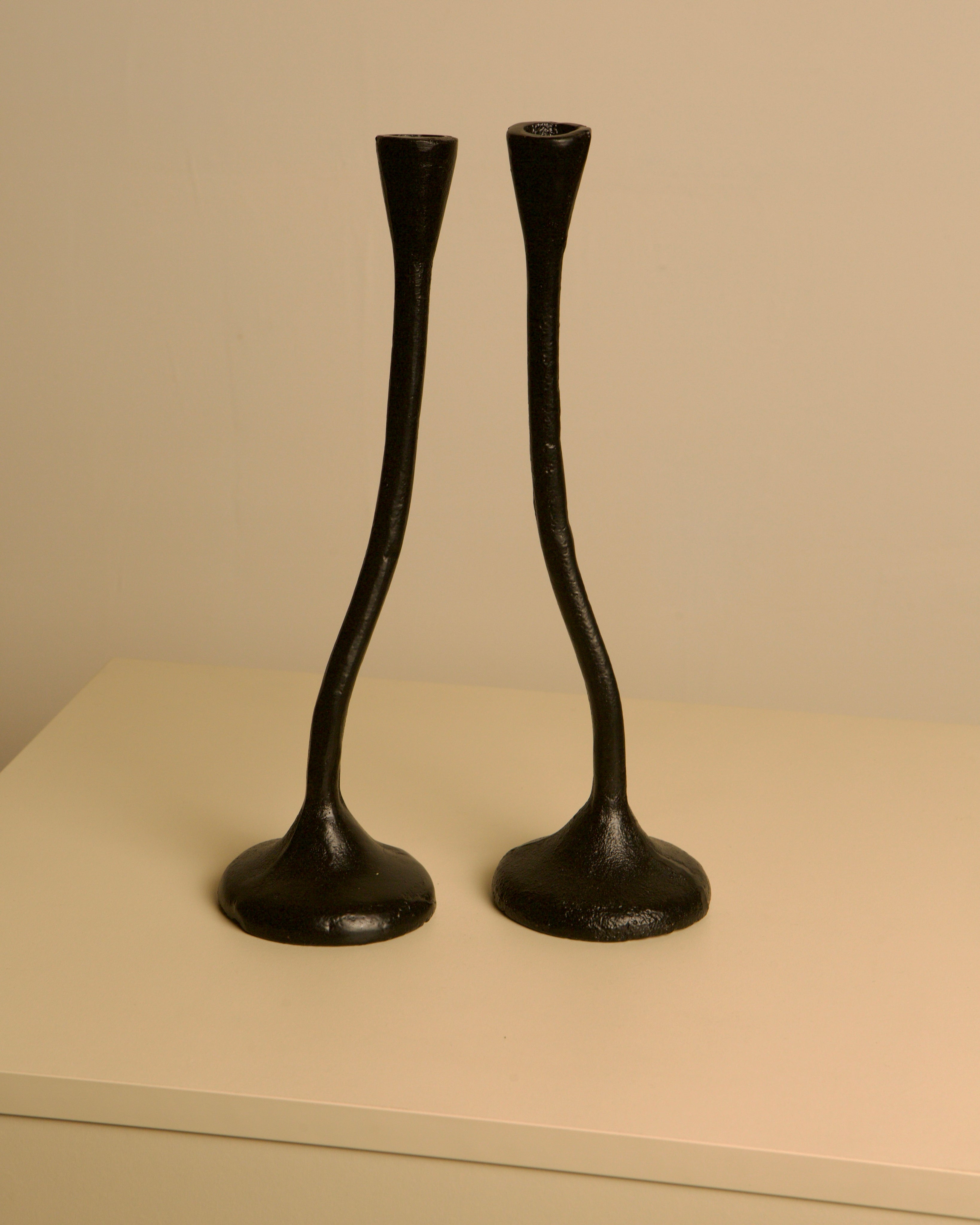 Set of 3 "Twisted" Candleholders in Black Cast Aluminum, 80s — back view on neutral background