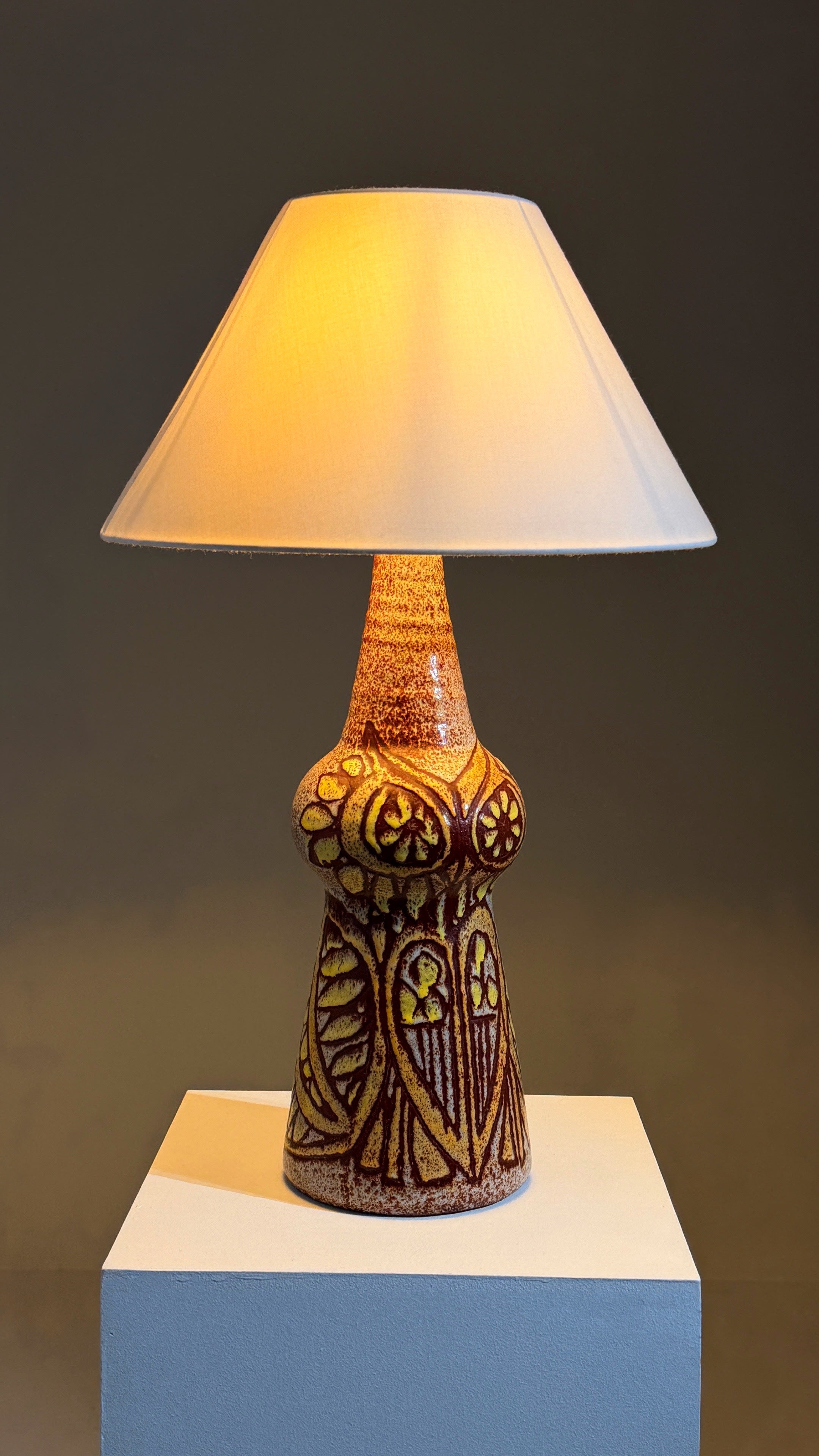 Rare ceramic lamp by the Accolay potters, France, circa 1960 — close-up of textured surface with warm light