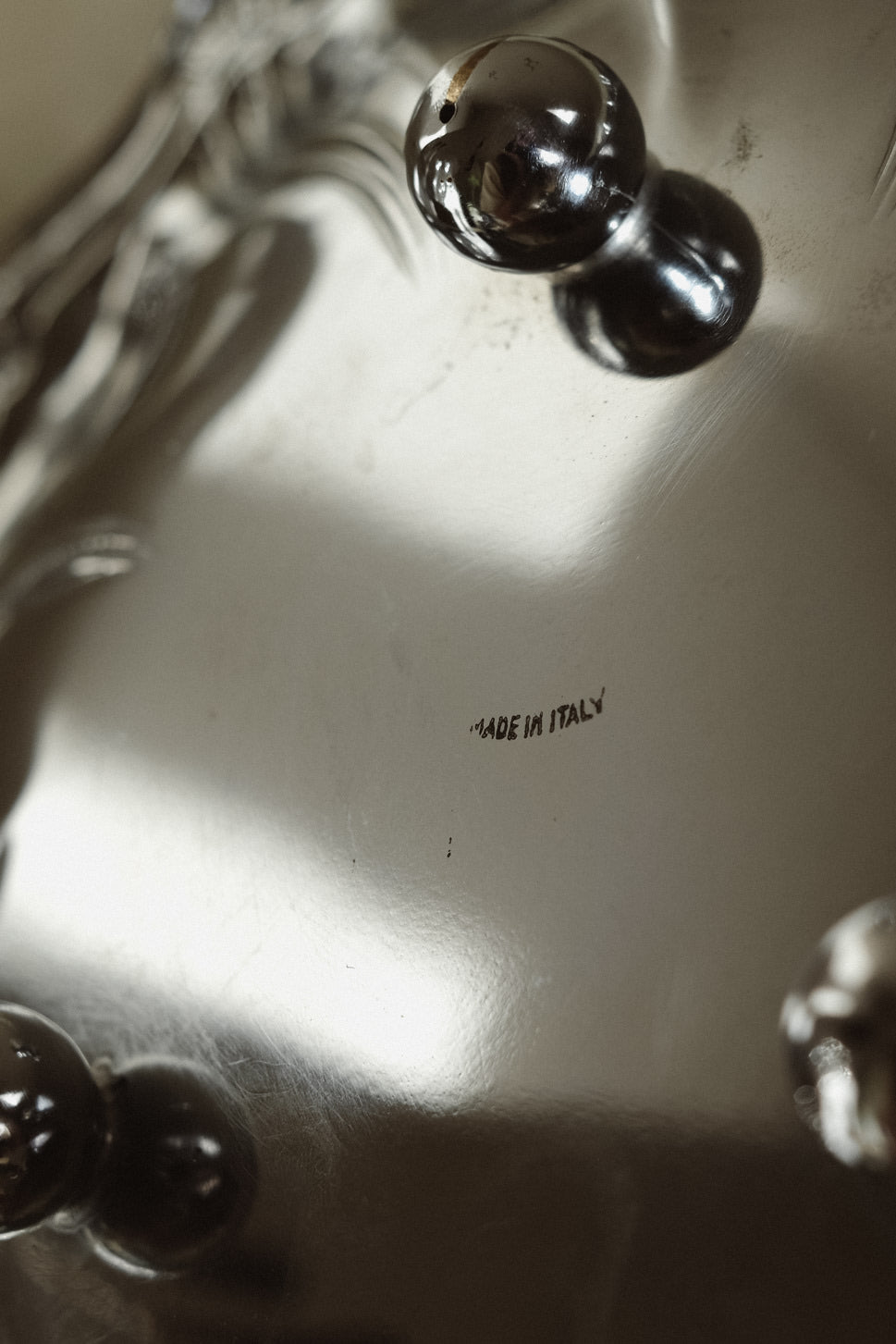 Italian Decorative Bowl — close-up of shiny silver surface with label