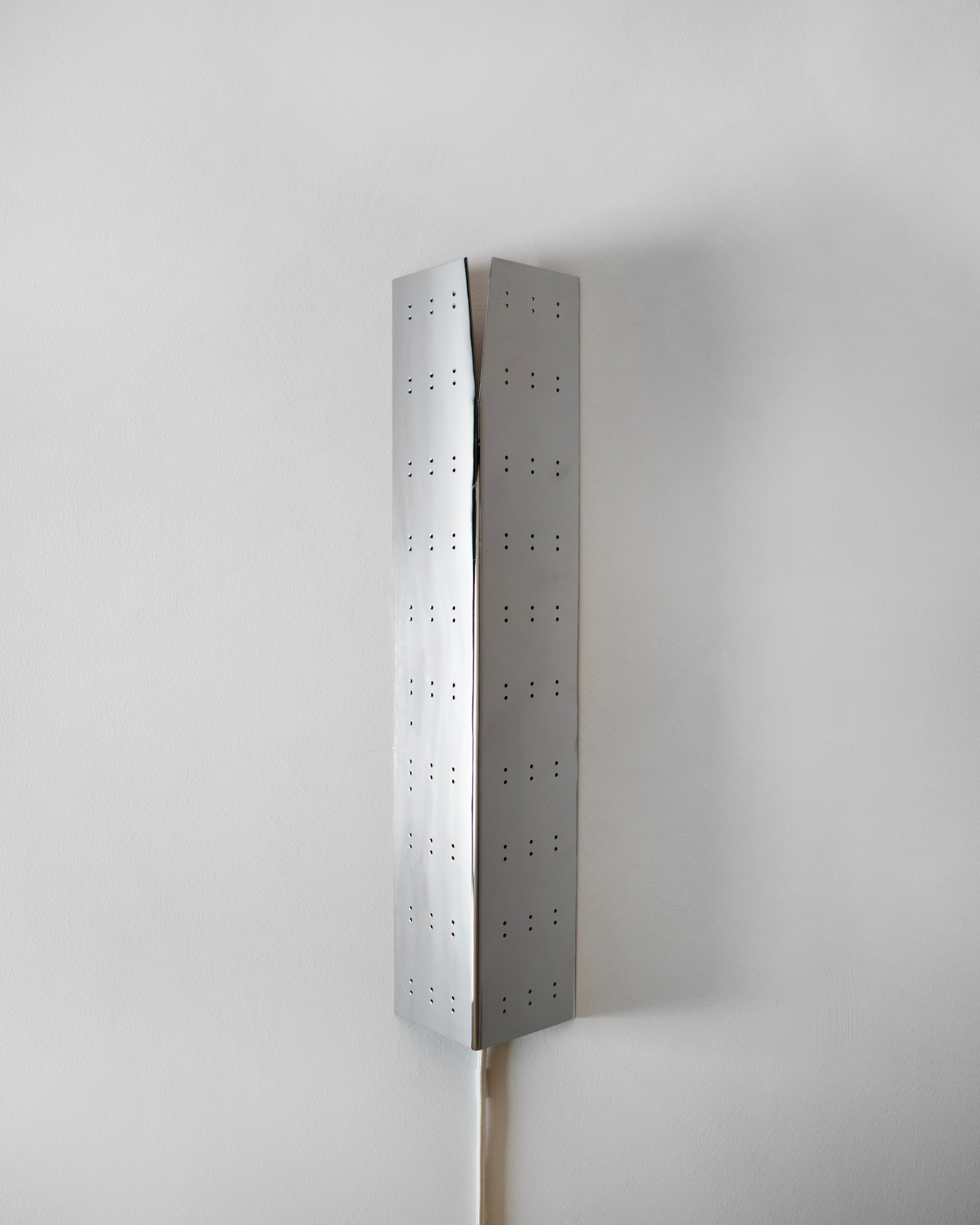 May Wall Lamp - Polished Steel — back view against white wall