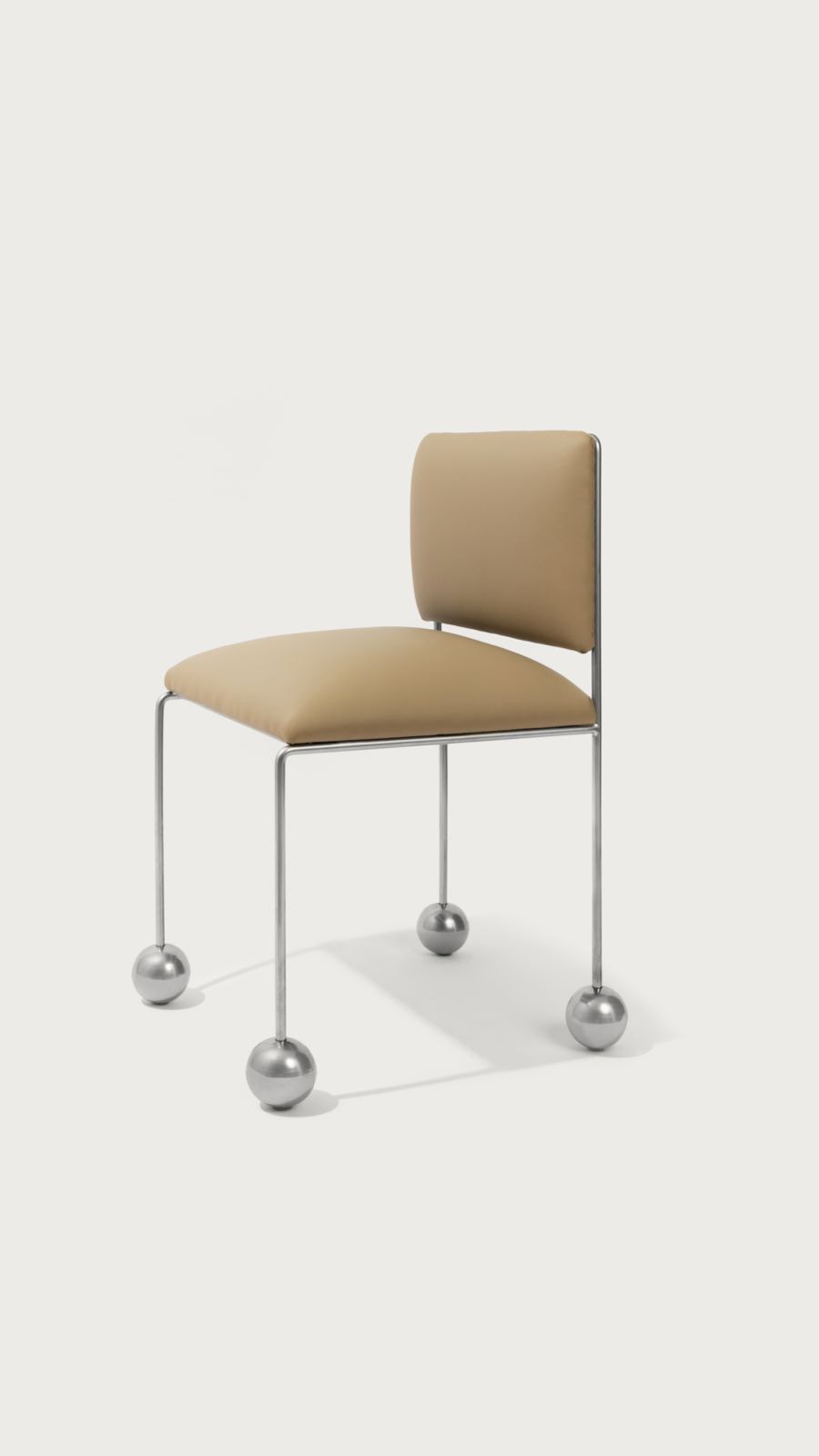 Ball Foot Sculptural Chair in (vegan) leather — side angle