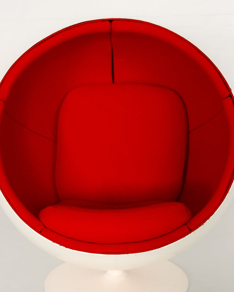 Interior view of red Ball chair showing curved upholstered seating