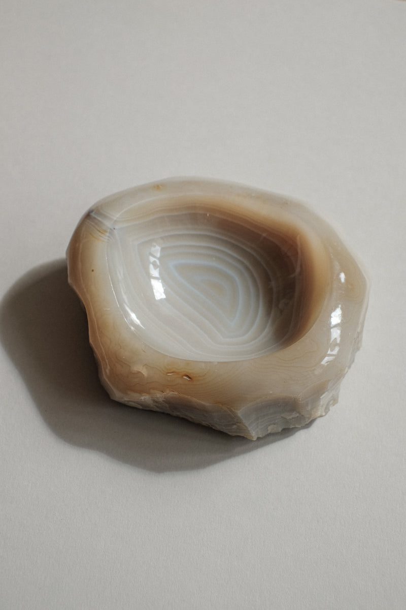 Natural agate bowl with concentric banded patterns in cream tones